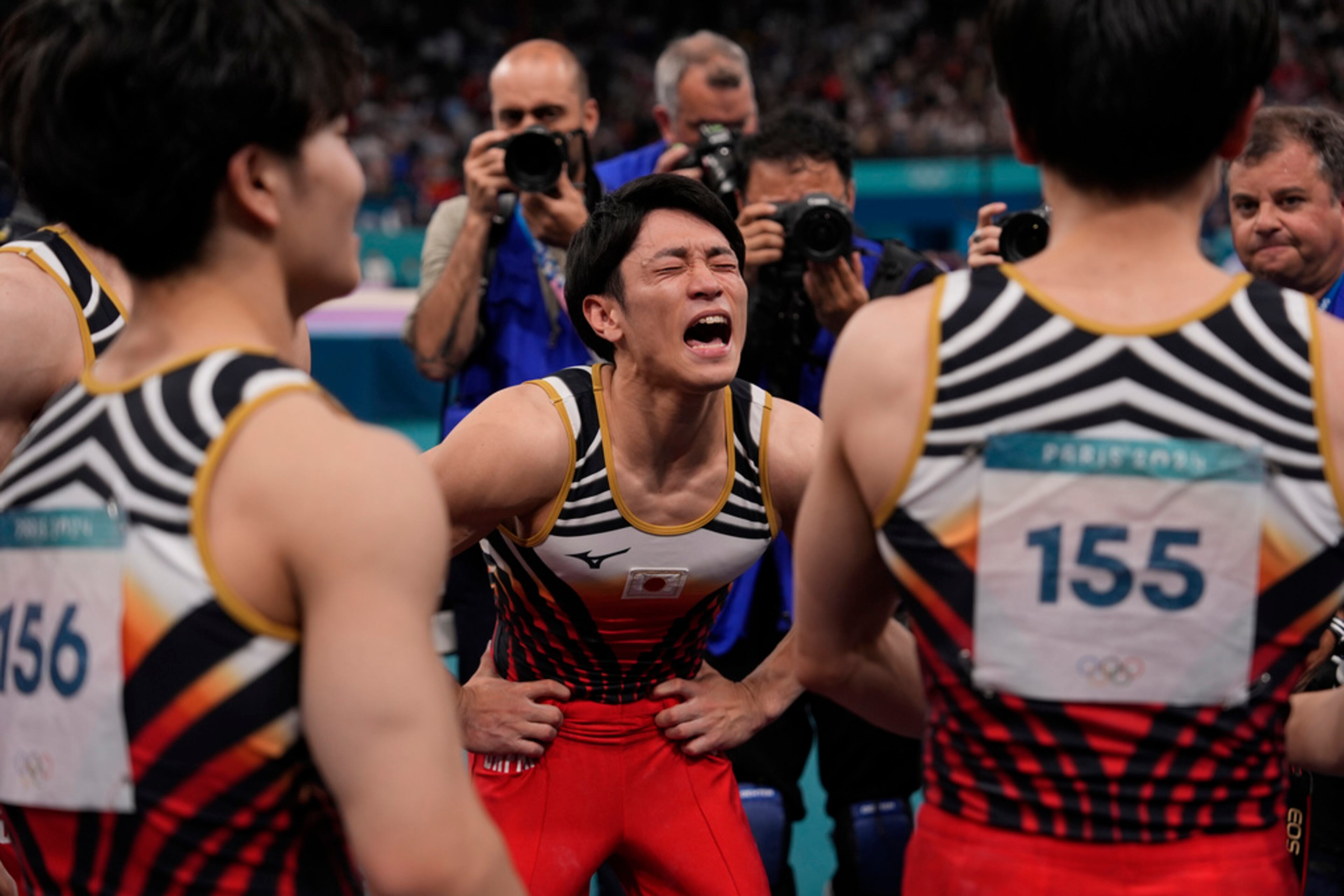 Members of Team Japan celebrate winning the Gold medal during the men's artistic gymnastics team finals round at Bercy Arena at the 2024 Summer Olympics, Monday, July 29, 2024, in Paris, France. (AP Photo/Charlie Riedel)