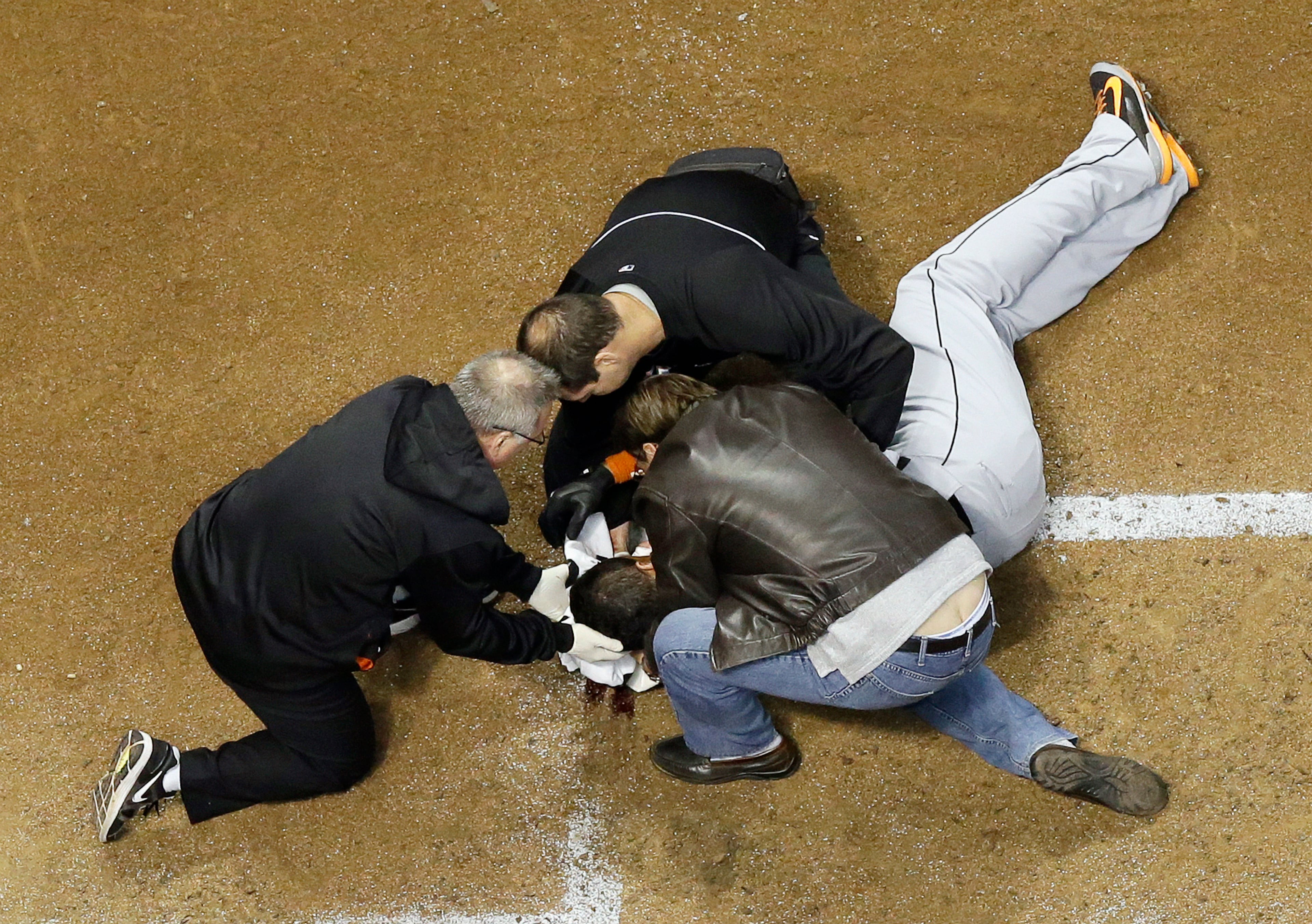 Miami Marlins' Giancarlo Stanton is attended to after being hit in the face with a pitch during the fifth inning of a baseball game against the Milwaukee Brewers Thursday, Sept. 11, 2014, in Milwaukee. Stanton was taken off the field on a stretcher. (AP Photo/Morry Gash)