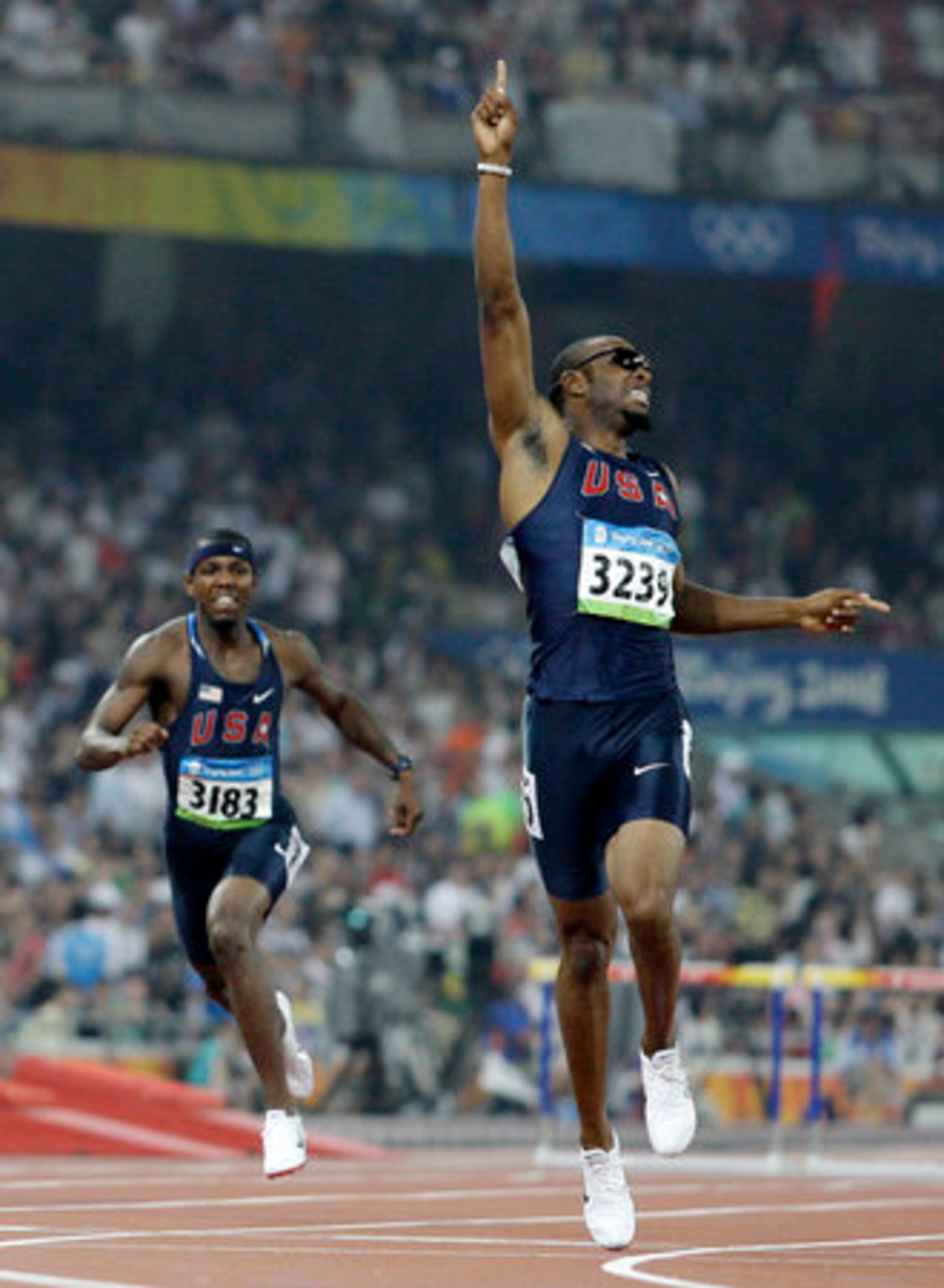 Taylor celebrates winning the gold in the men's 400-meter hurdles.