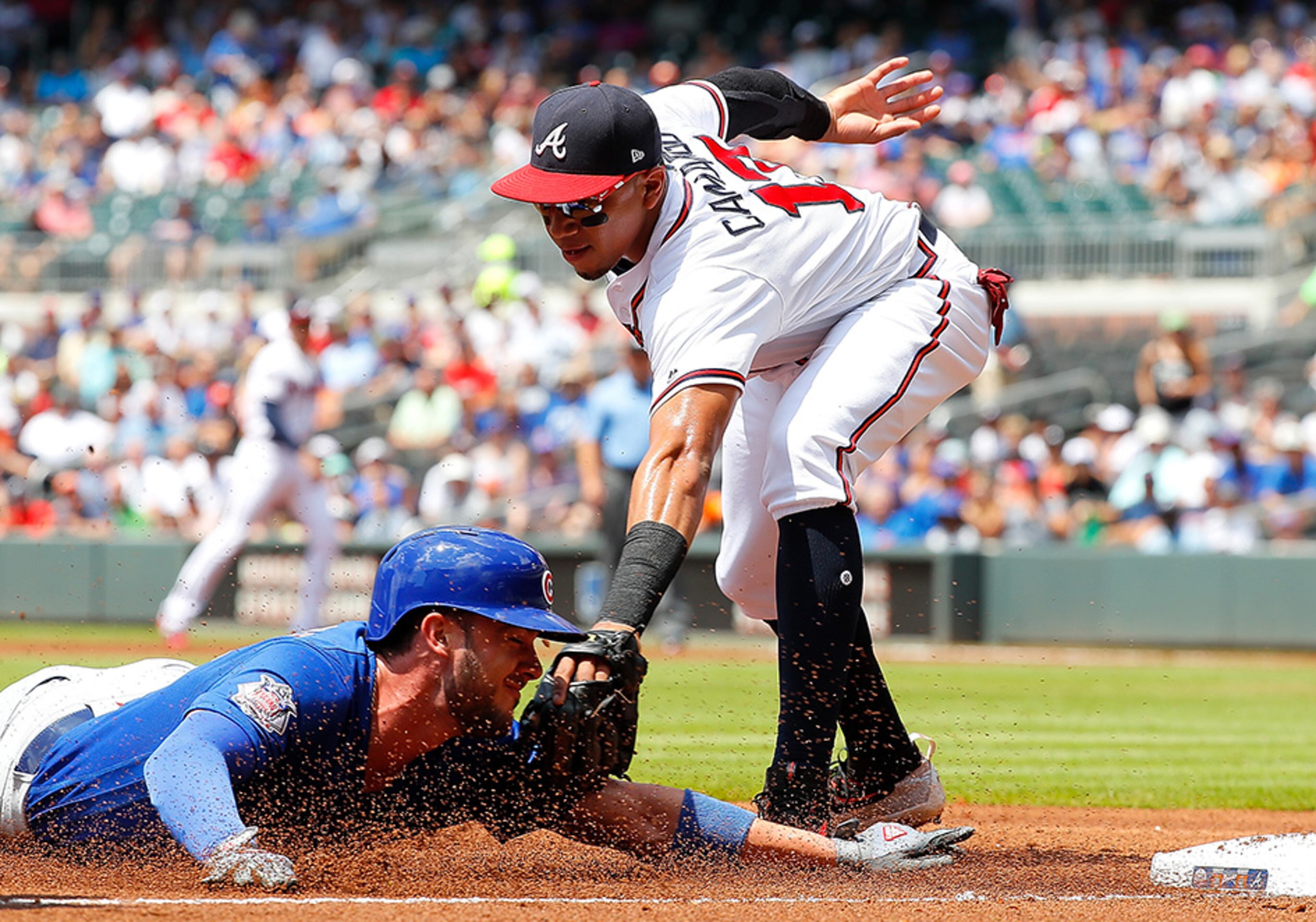 ATLANTA, GA - JULY 19: Kris Bryant #17 of the Chicago Cubs is tagged out while trying to steal third base against Johan Camargo #17 of the Atlanta Braves in the first inning at SunTrust Park on July 19, 2017 in Atlanta, Georgia. (Photo by Kevin C. Cox/Getty Images)