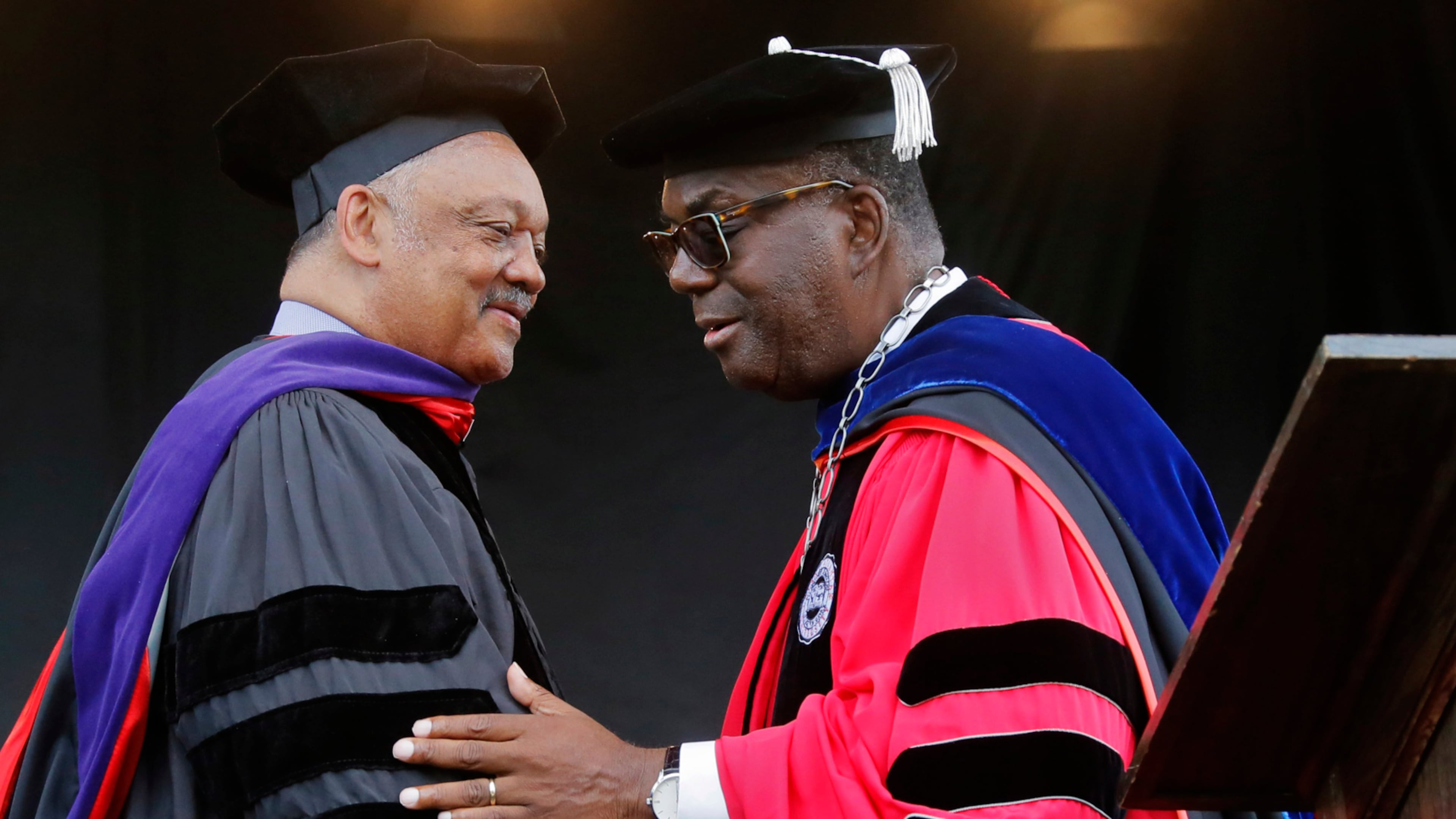 Rev. Jesse Jackson, left, is congratulated by then-Clark Atlanta University President Ronald Johnson after he received an honorary degree during the university's 2017 commencement ceremony. (AJC file photo)