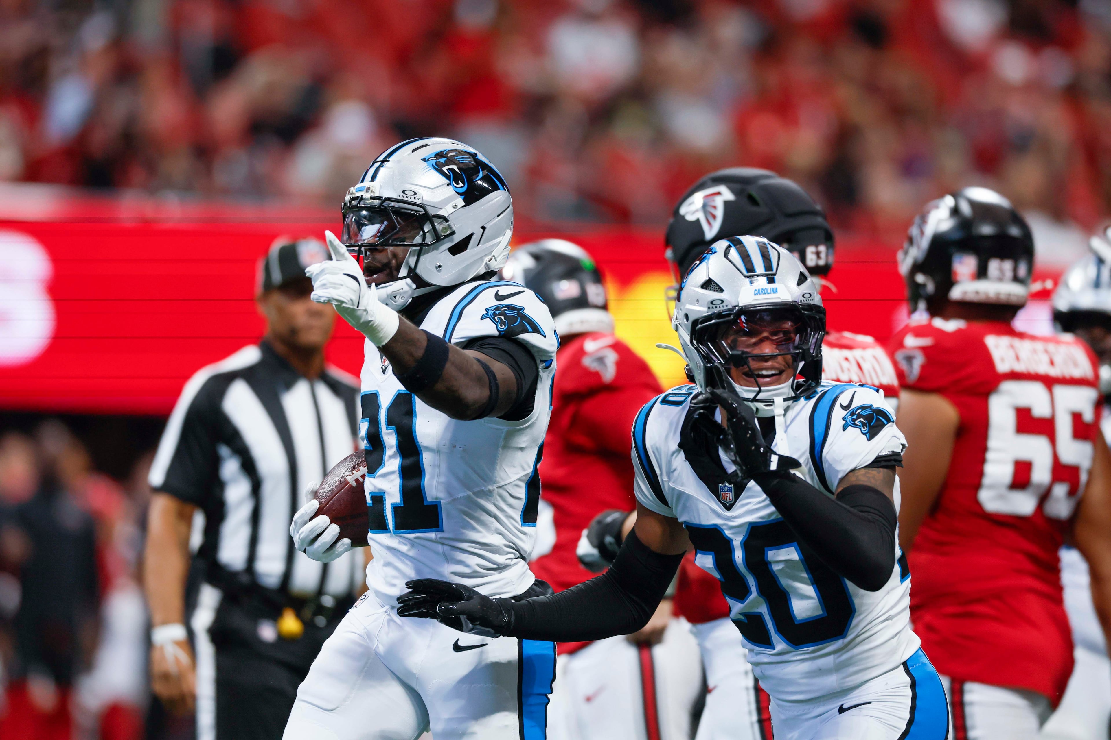 Carolina Panthers safety Nick Scott (21), left, celebrates with Carolina Panthers safety Zakee Wheatley (20 after recovering a fumble during the first half of an NFL game against the Atlanta Falcons at Mercedes-Benz Stadium in Atlanta on Sunday, September 20, 2026. (Miguel Martinez/AJC)