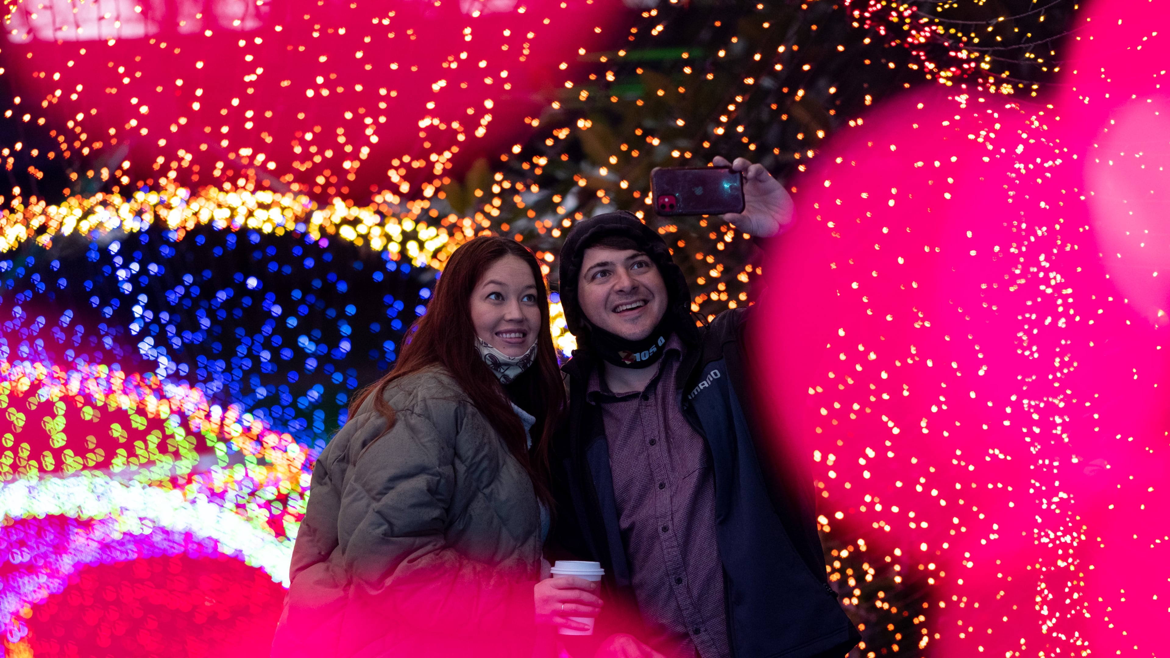 201231-Atlanta-Visitors walk through a tunnel of lights while spending New Year’s Eve at the Atlanta Botanical Gardens for their Garden Lights, Holiday Nights display Thursday evening, Dec. 31, 2020 in Decatur. Ben Gray for the Atlanta Journal-Constitution