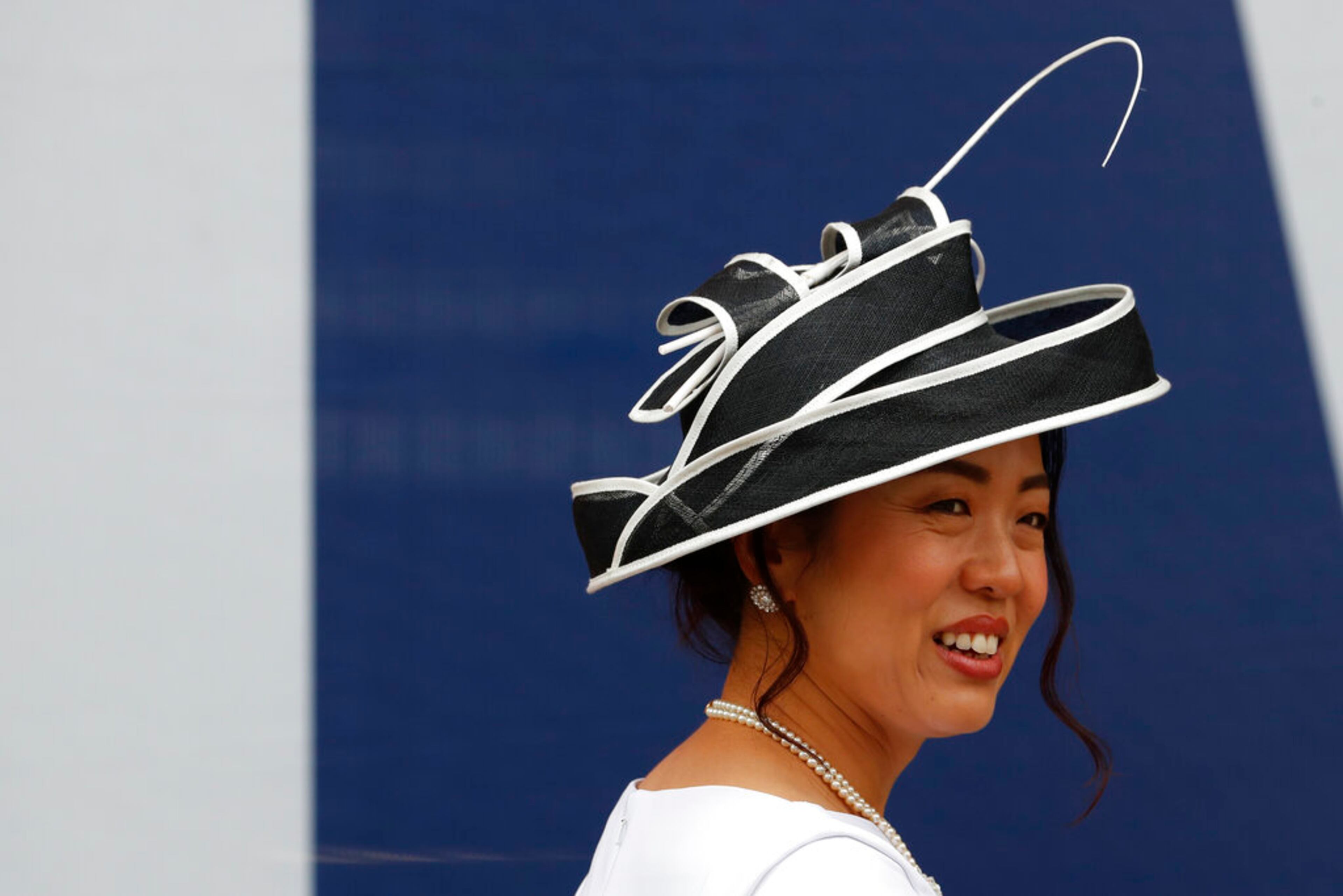 A racegoer arrives on the second day of the annual Royal Ascot horse race meeting in Ascot, England, Wednesday, June 19, 2019. (AP Photo/Alastair Grant)