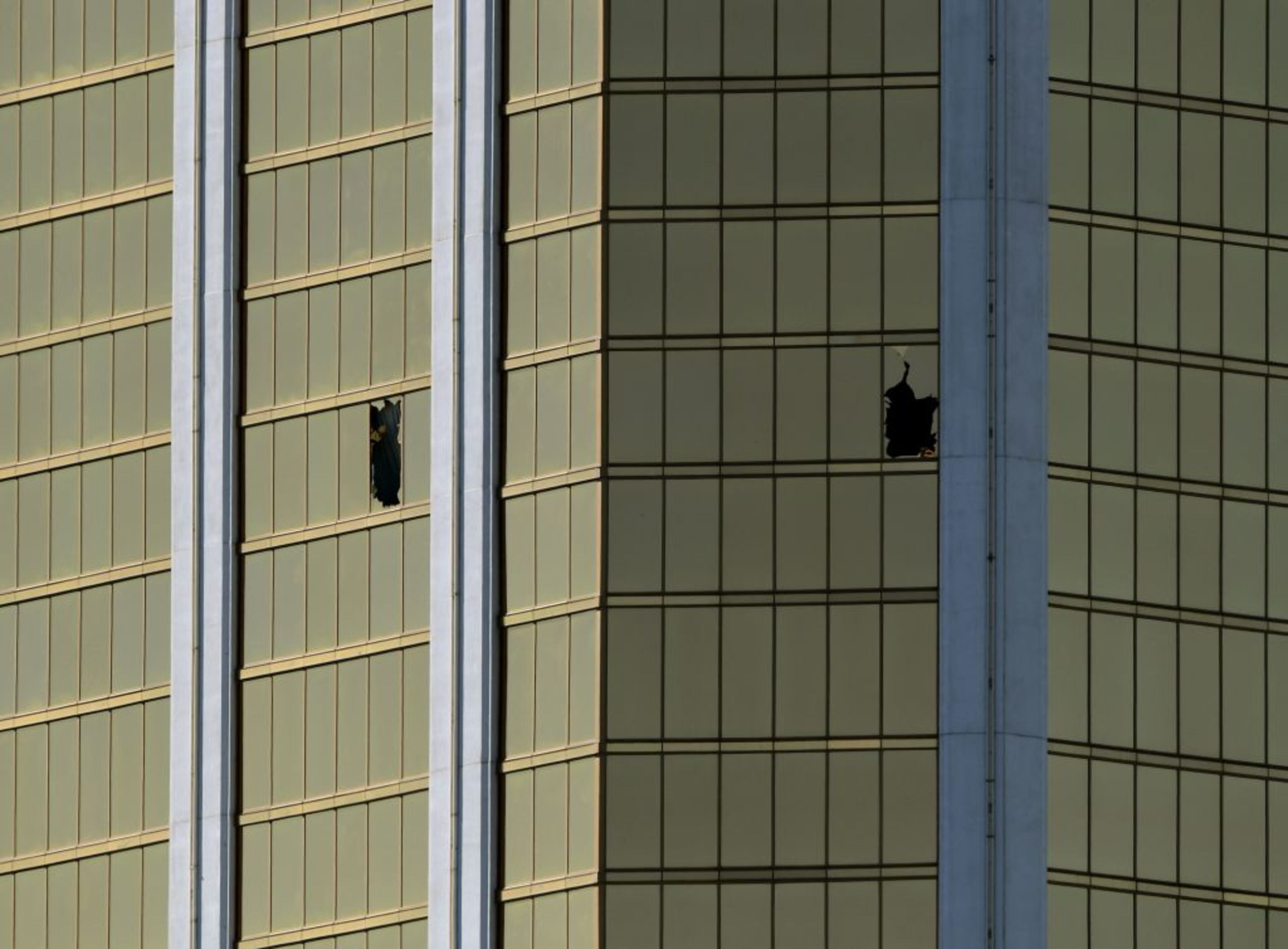 The damaged windows on the 32nd floor room that was used by the shooter in the Mandalay Hotel after a gunman killed at least 58 people and wounded more than 500 others when he opened fire on a country music concert in Las Vegas, Nevada on October 2, 2017. Police said the gunman, a 64-year-old local resident named as Stephen Paddock, had been killed after a SWAT team responded to reports of multiple gunfire from the 32nd floor of the Mandalay Bay, a hotel-casino next to the concert venue. (MARK RALSTON/AFP/Getty Images)