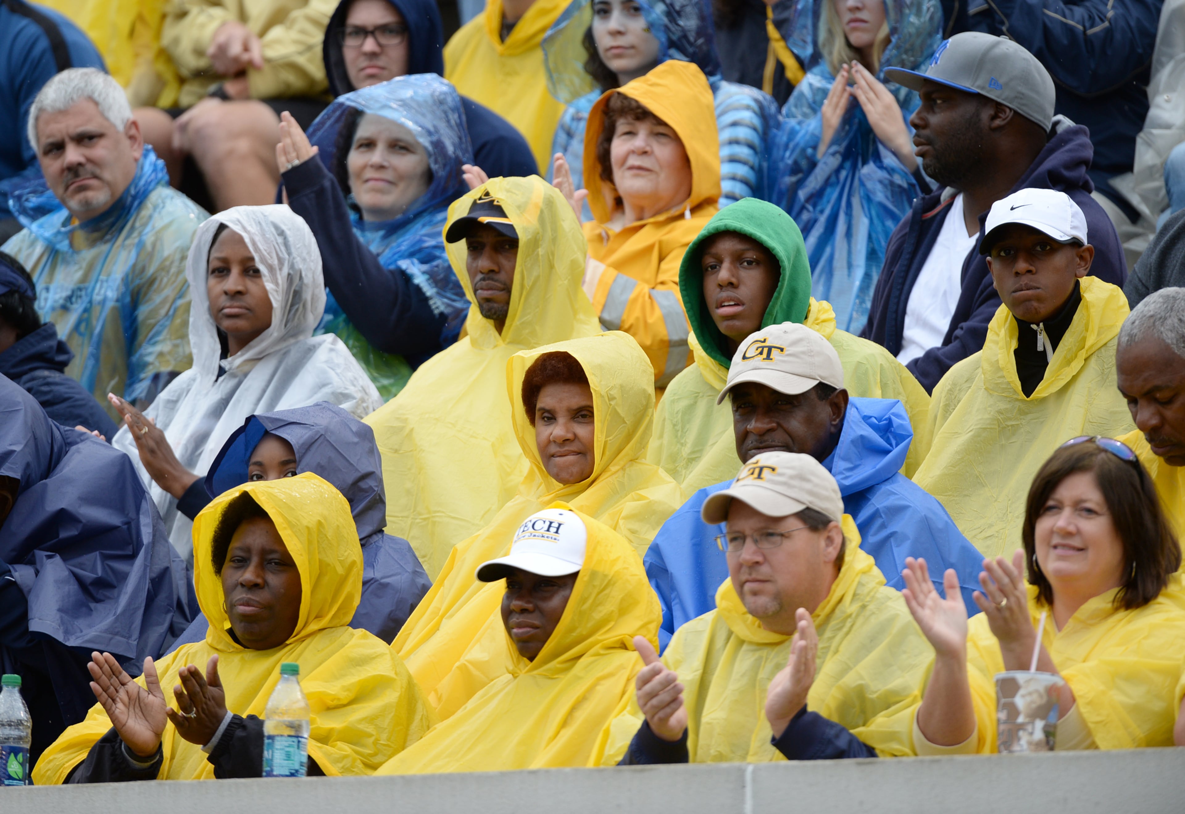 Georgia Tech fans sit in the ran during the football game in Bobby Dodd Stadium against Syracuse University on Saturday, October 19, 2013. Georgia Tech won the game 56-0.