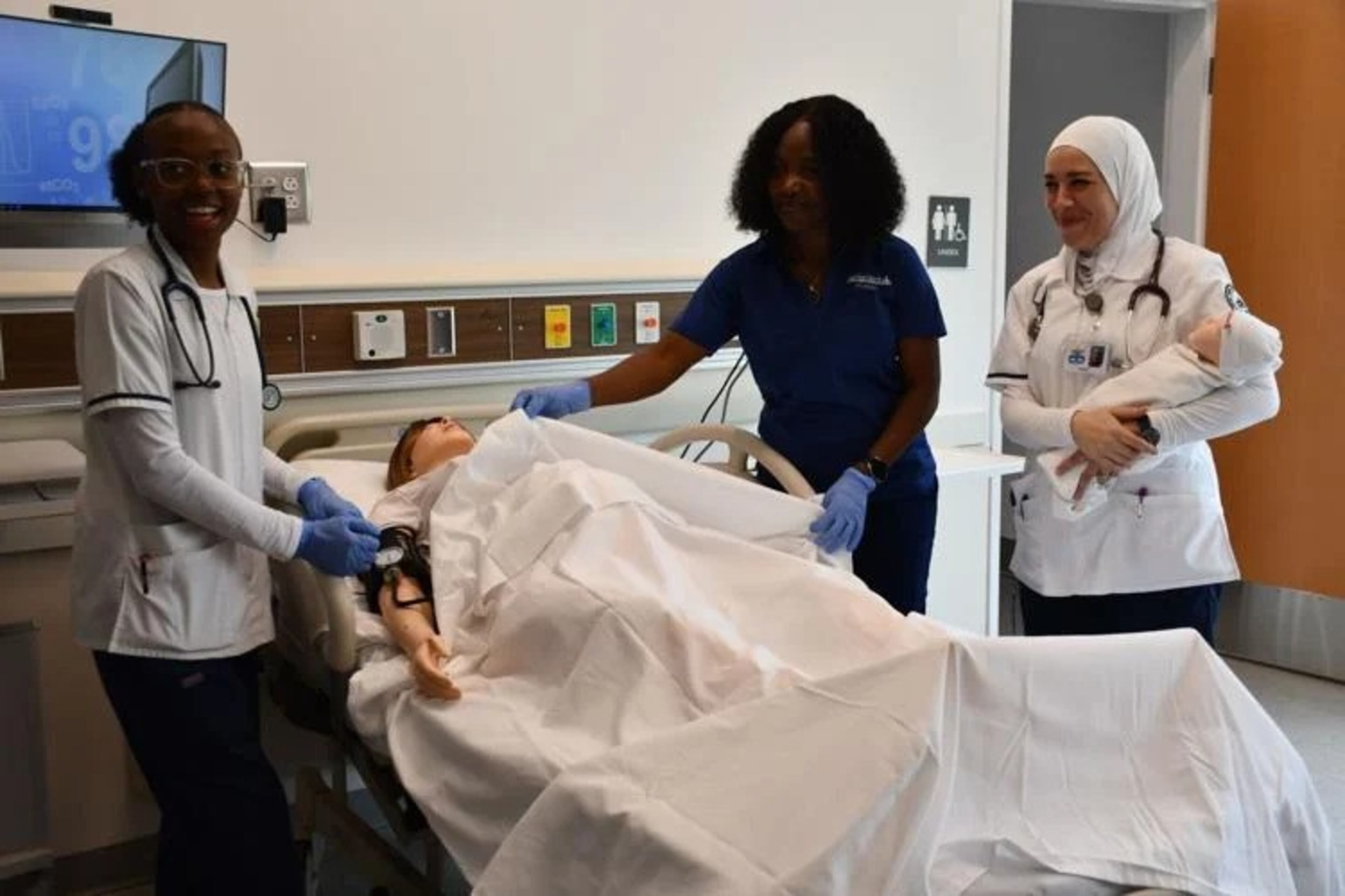 ASU students use new simulation room in Nursing and Health Sciences Simulation Center. This mannequin can deliver a baby. (Photo Courtesy of Lucille Lannigan)