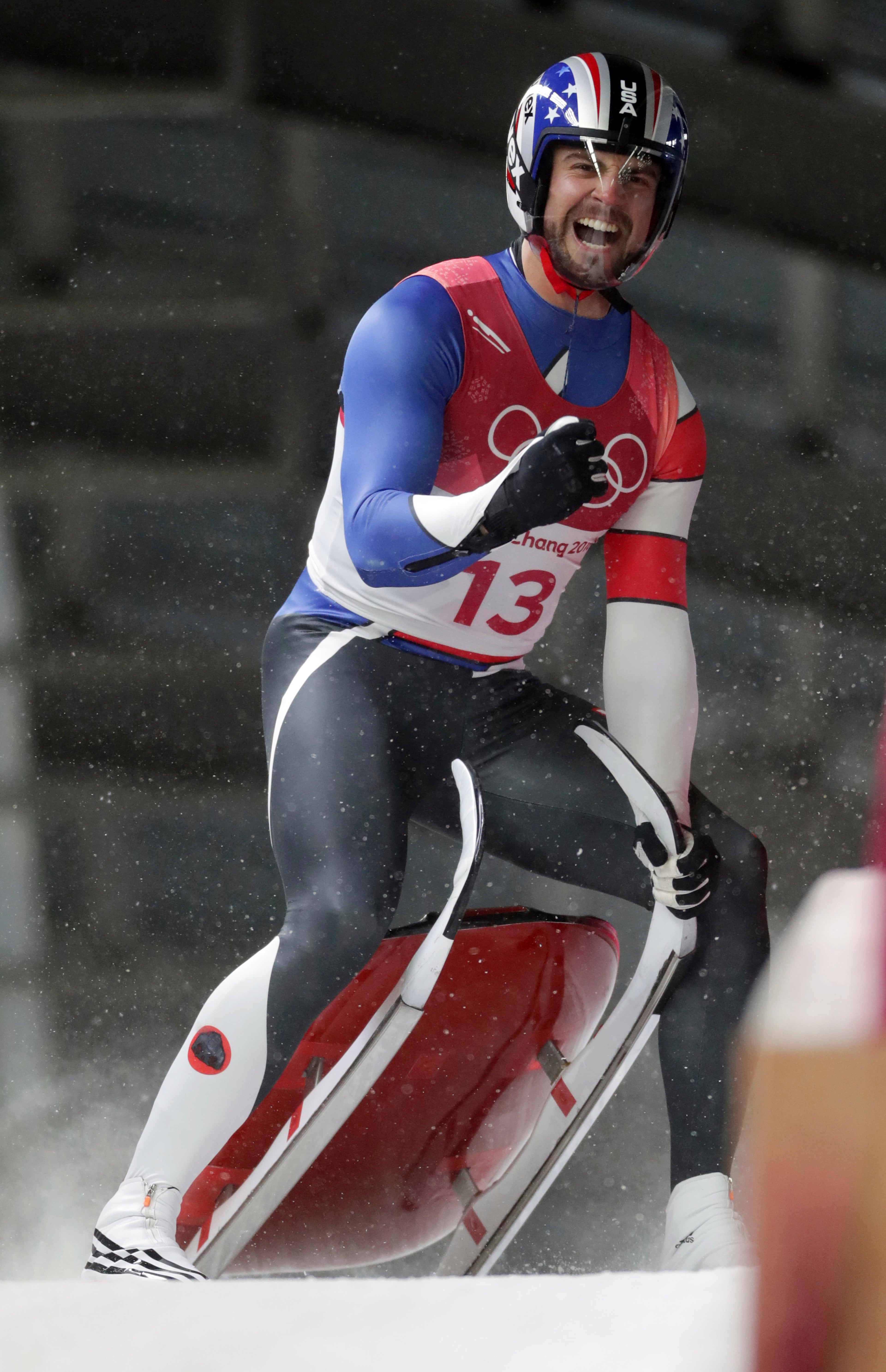 Chris Mazdzer of United States celebrates his silver medal final run during final heats of the men's luge competition at the 2018 Winter Olympics in Pyeongchang, South Korea, Sunday, Feb. 11, 2018. (AP Photo/Michael Sohn)