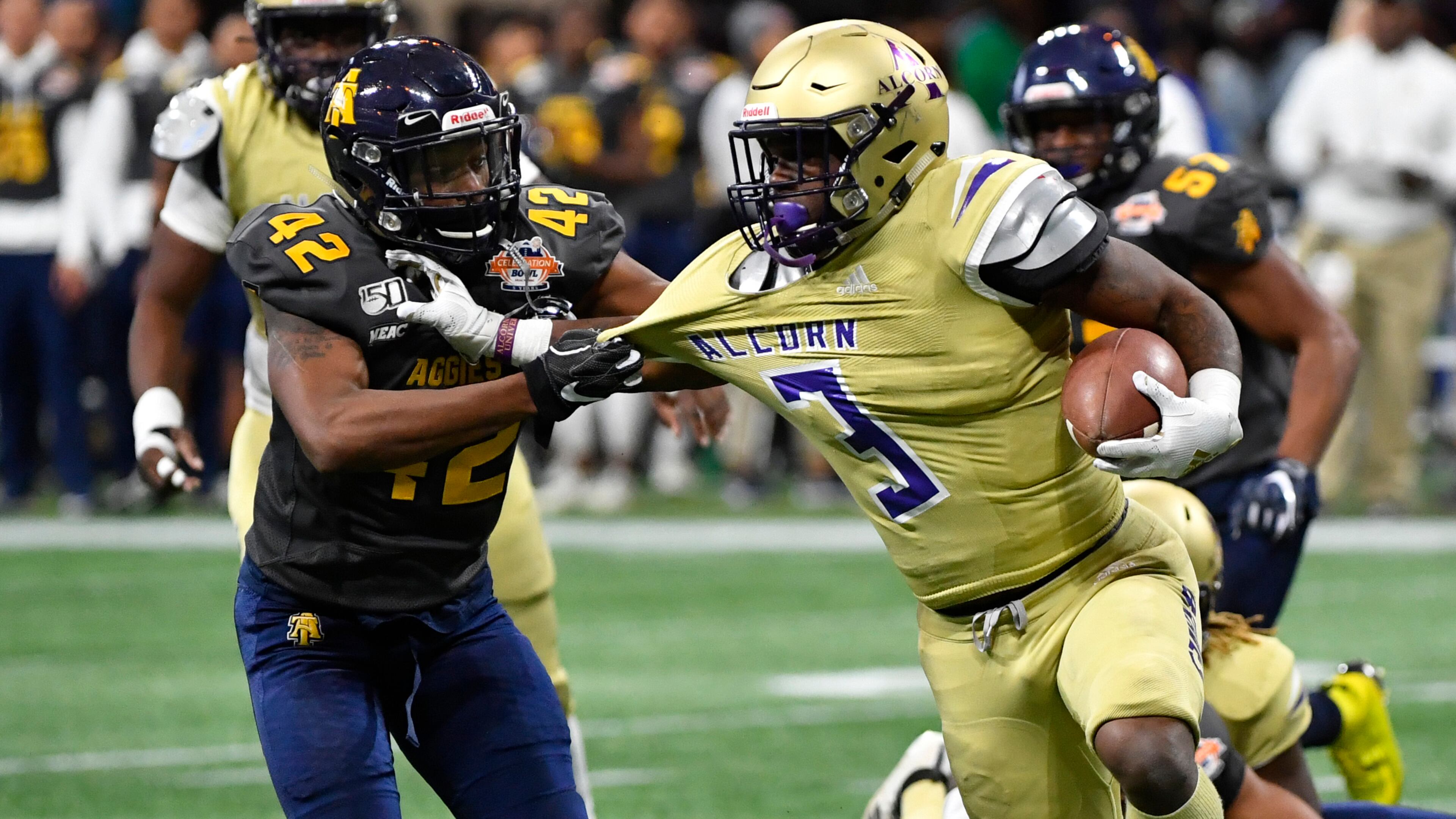 Alcorn State running back De'Shawn Waller (3) is grabbed by North Carolina A&T defensive back Will Jones (42) during the second half of the Celebration Bowl Saturday, Dec. 21, 2019, at Mercedes-Benz Stadium in Atlanta.