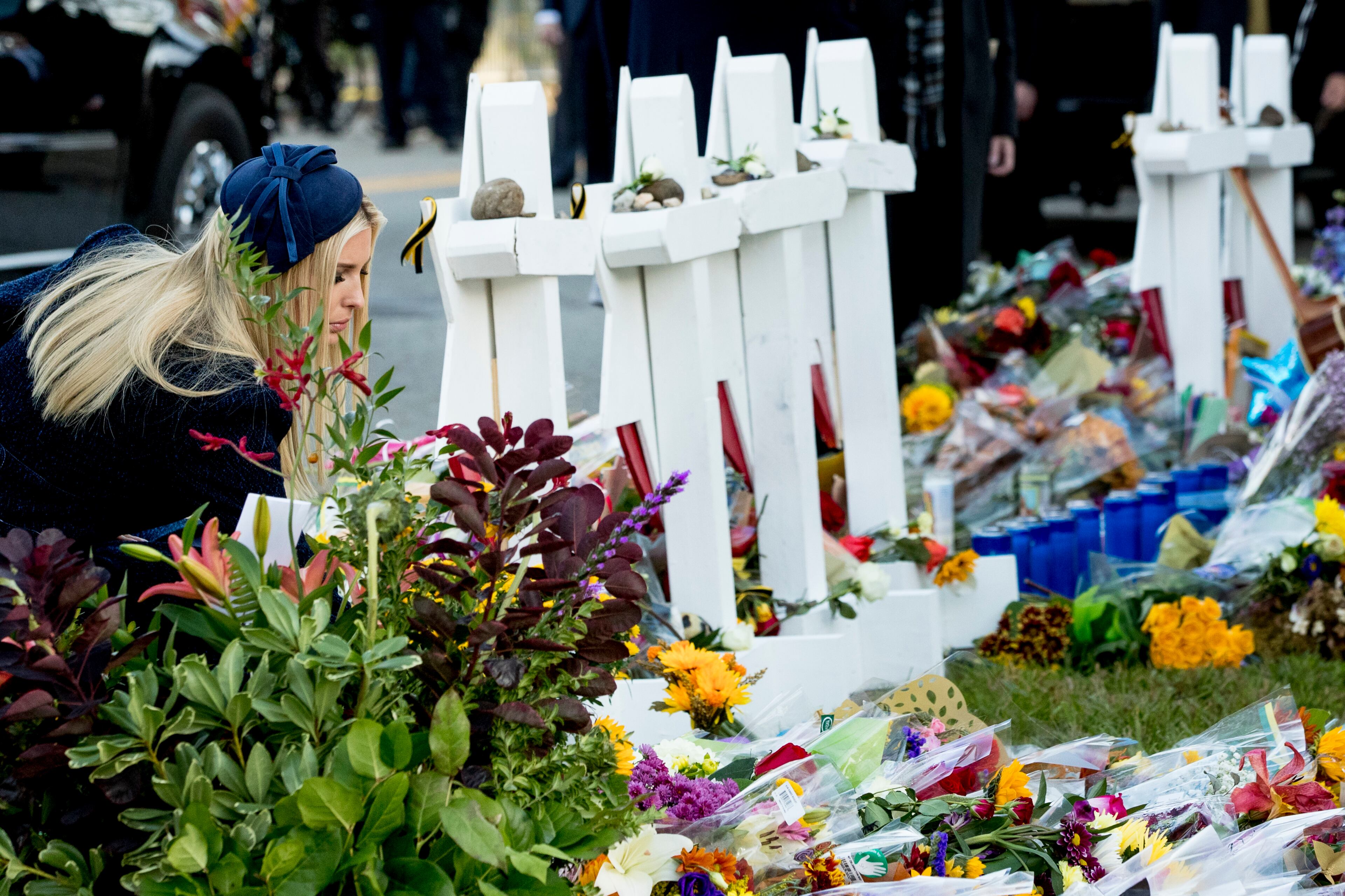 Ivanka Trump, the daughter of President Donald Trump, kneels at a memorial outside for those killed at the Tree of Life Synagogue in Pittsburgh, Tuesday, Oct. 30, 2018. (AP Photo/Andrew Harnik)