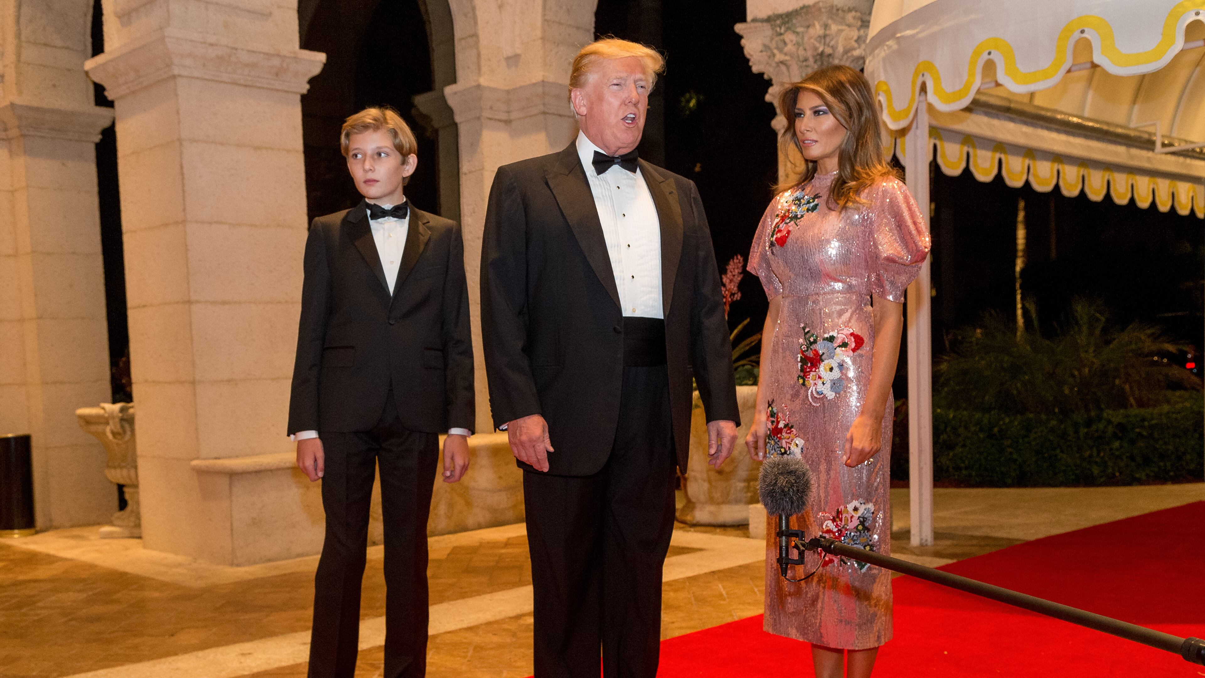 Barron Trump, left with his father, President Donald Trump and first lady Melania Trump walk the red carpet to the ballroom for the Mar-a-Lago New Year's Eva Gala at Mar-a-Lago in Palm Beach, Sun., December 31, 2017 in Palm Beach, Fla. (Greg Lovett / The Palm Beach Post)