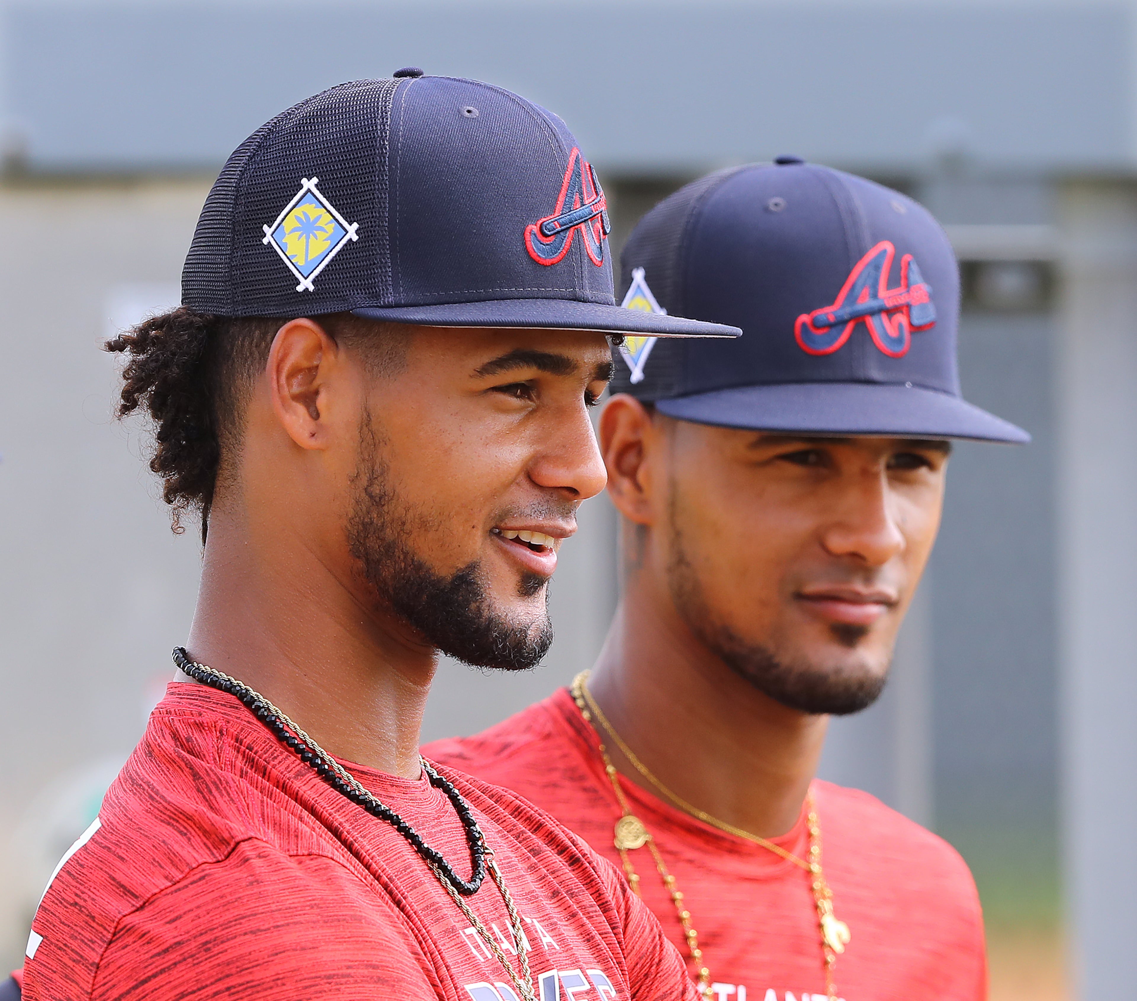 Braves pitching prospects and identical twins Roddery Munoz (left) and Rolddy Munoz prepare to begin a session on the practice pitching mounds at the Braves minor league spring training camp on Wednesday, March 9, 2022, in North Port. “Curtis Compton / Curtis.Compton@ajc.com”`