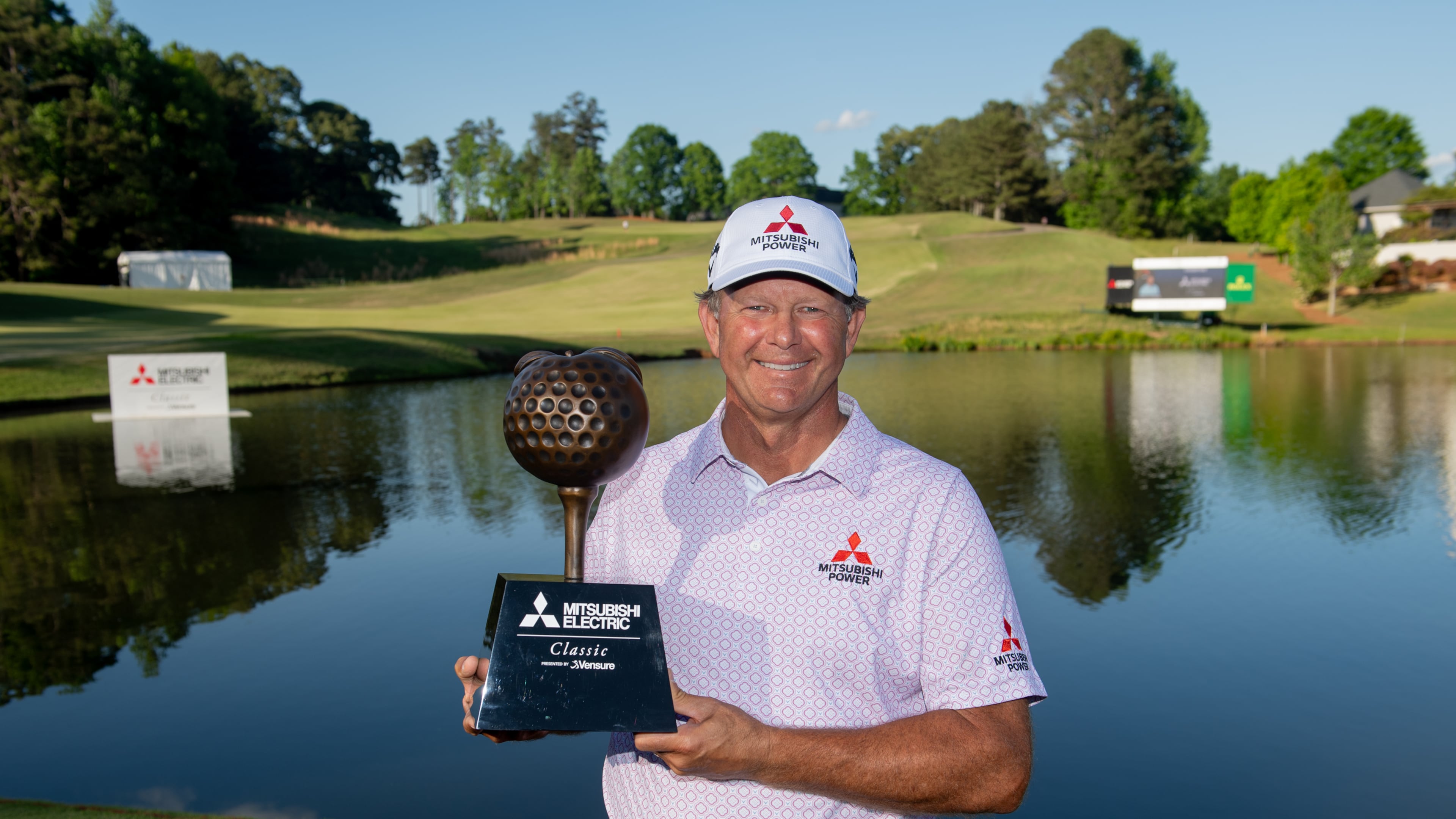Retief Goosen holds the trophy for winning the Mitsubishi Electric Classic, April 26, 2026, at TPC Sugarloaf. Photo Kate Awtrey-King.