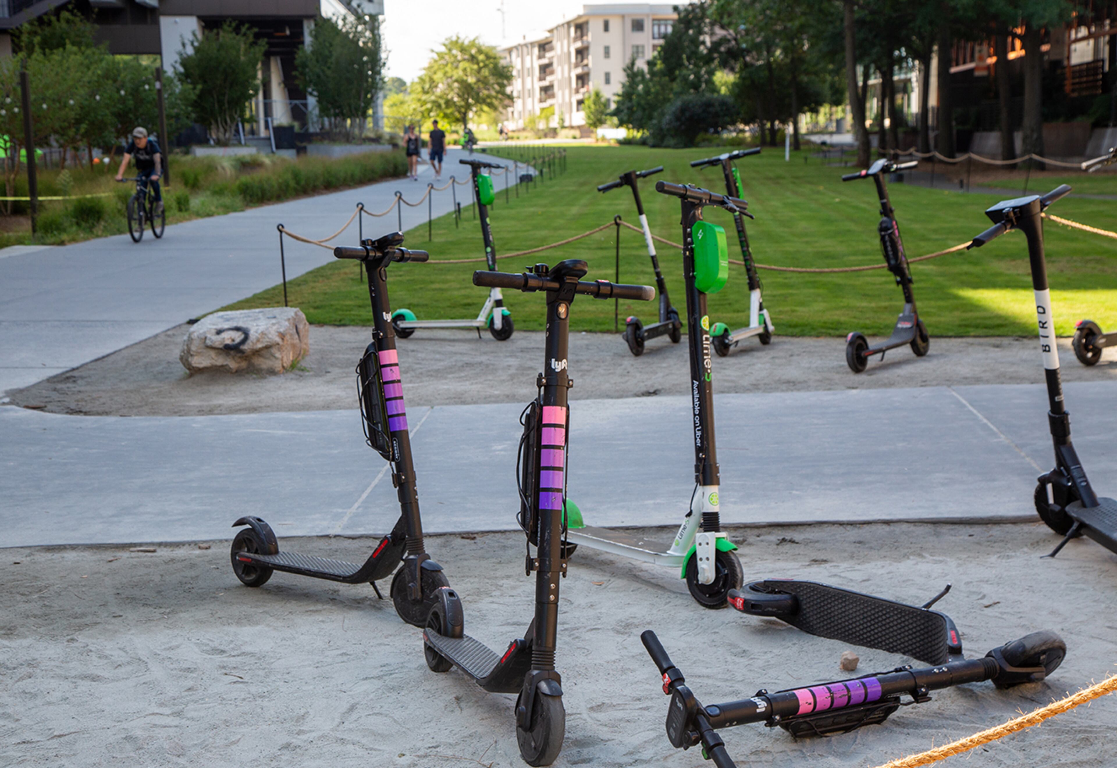 Multiple e-scooters parked at the Beltine entrance to Ponce City Market in Atlanta on Thursday August 22nd, 2019. He shares his thoughts on e-scooters. The Beltline started out prohibiting motorized vehicles. In January, the Atlanta City Council passed a law allowing for e-scooters to be used on the trails. Does this compromise the Beltline's purpose? (Photo by Phil Skinner)