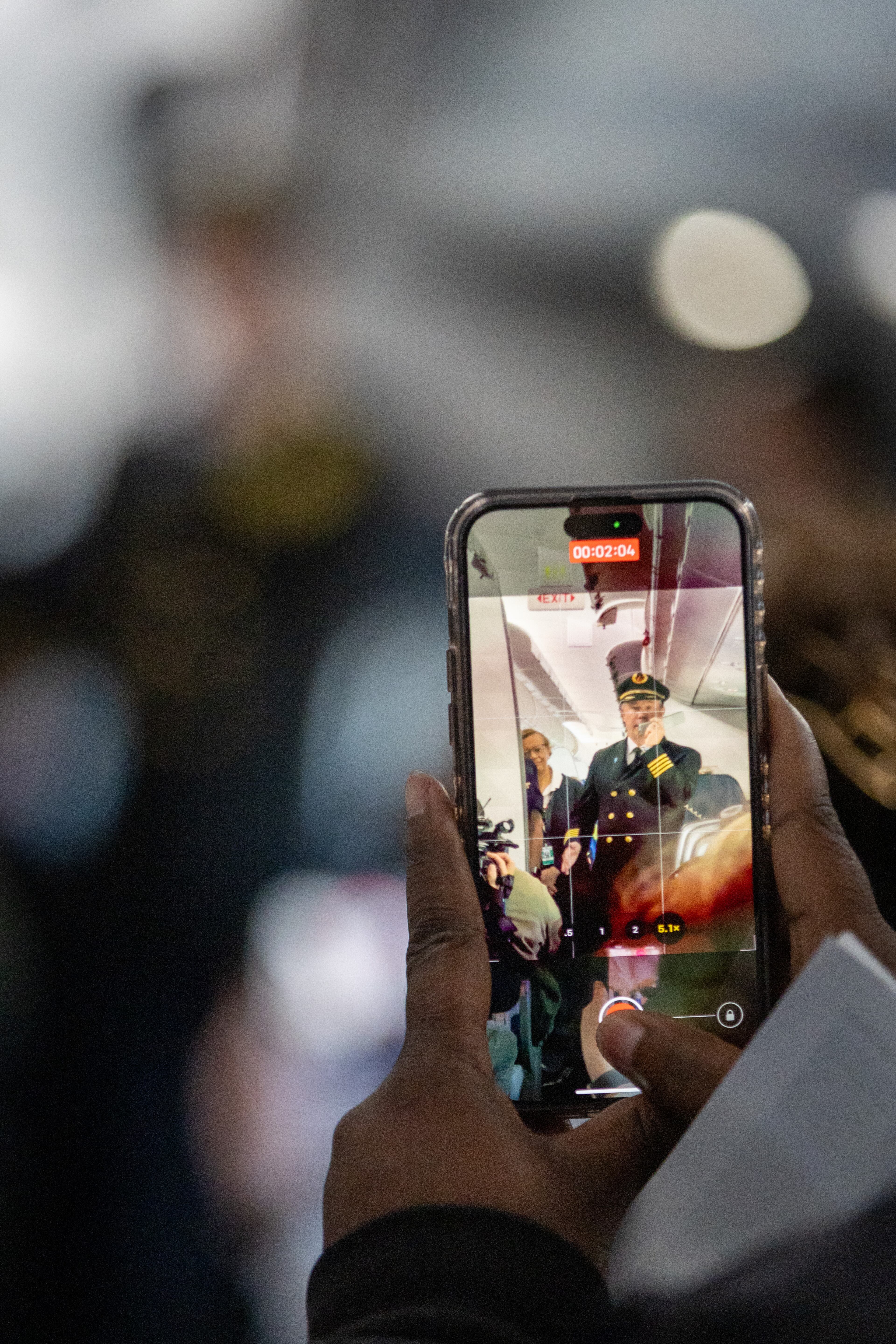 Participants video Delta pilot Erich A Ries as he talks with the group during a Wings For All event at the Hartsfield-Jackson Atlanta International Airport Tuesday, April 11, 2023. (Steve Schaefer/steve.schaefer@ajc.com)