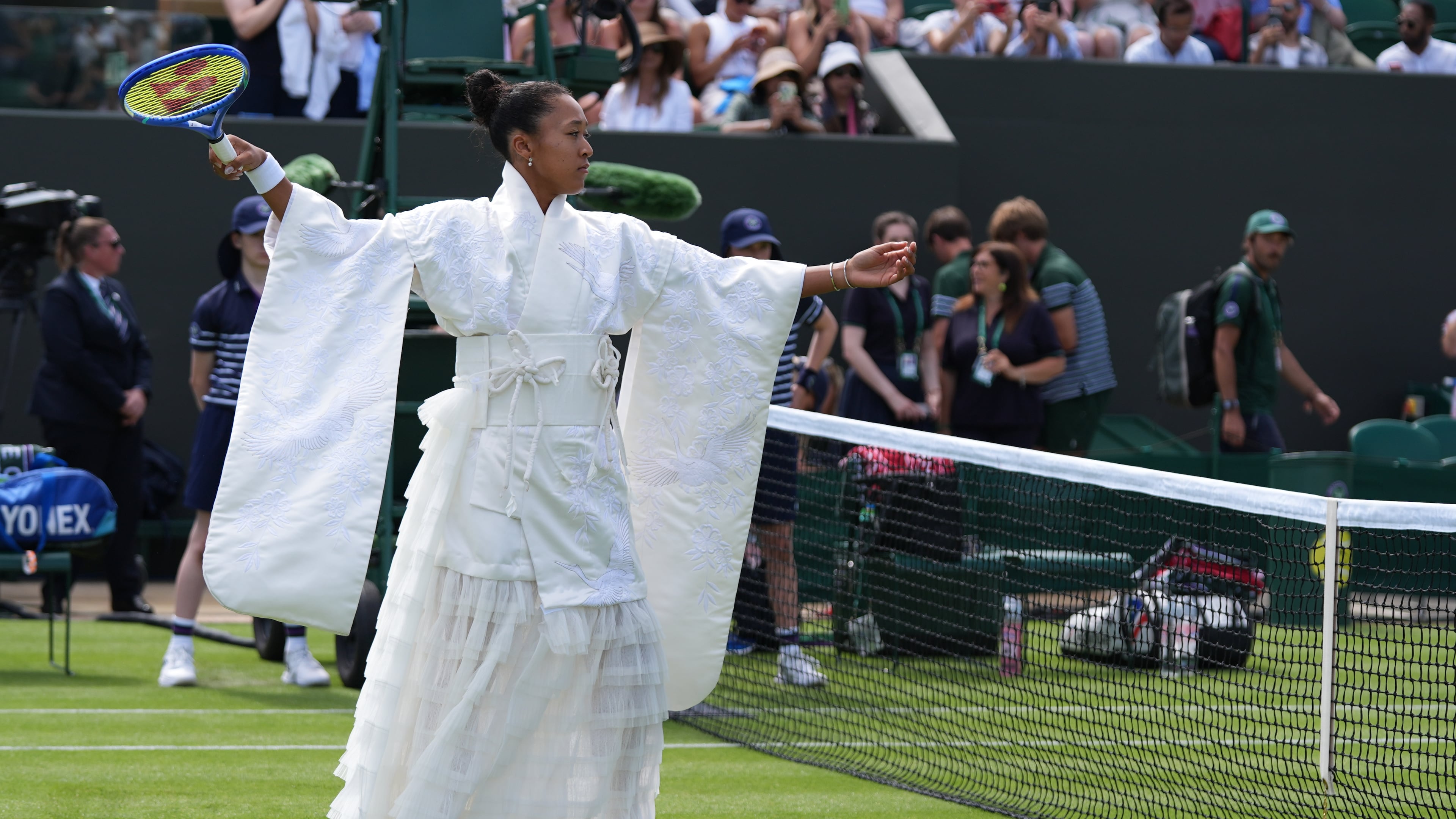 Naomi Osaka of Japan walks into the court to play against Elsa Jacquemot of France in their first round women's singles match at the Wimbledon Tennis Championships in London, Monday, June 29, 2026. (AP Photo/Maja Smiejkowska)