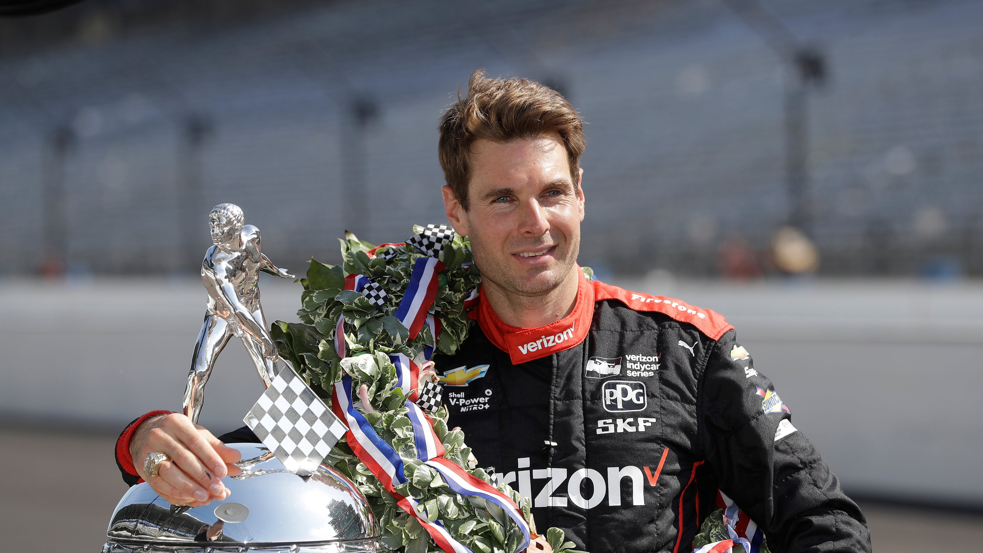 FILE Indianapolis 500 champion Will Power, of Australia, poses with the Borg-Warner Trophy during the traditional winners photo session on the start/finish line at the Indianapolis Motor Speedway, May 28, 2018, in Indianapolis. (AP Photo/Darron Cummings, File)