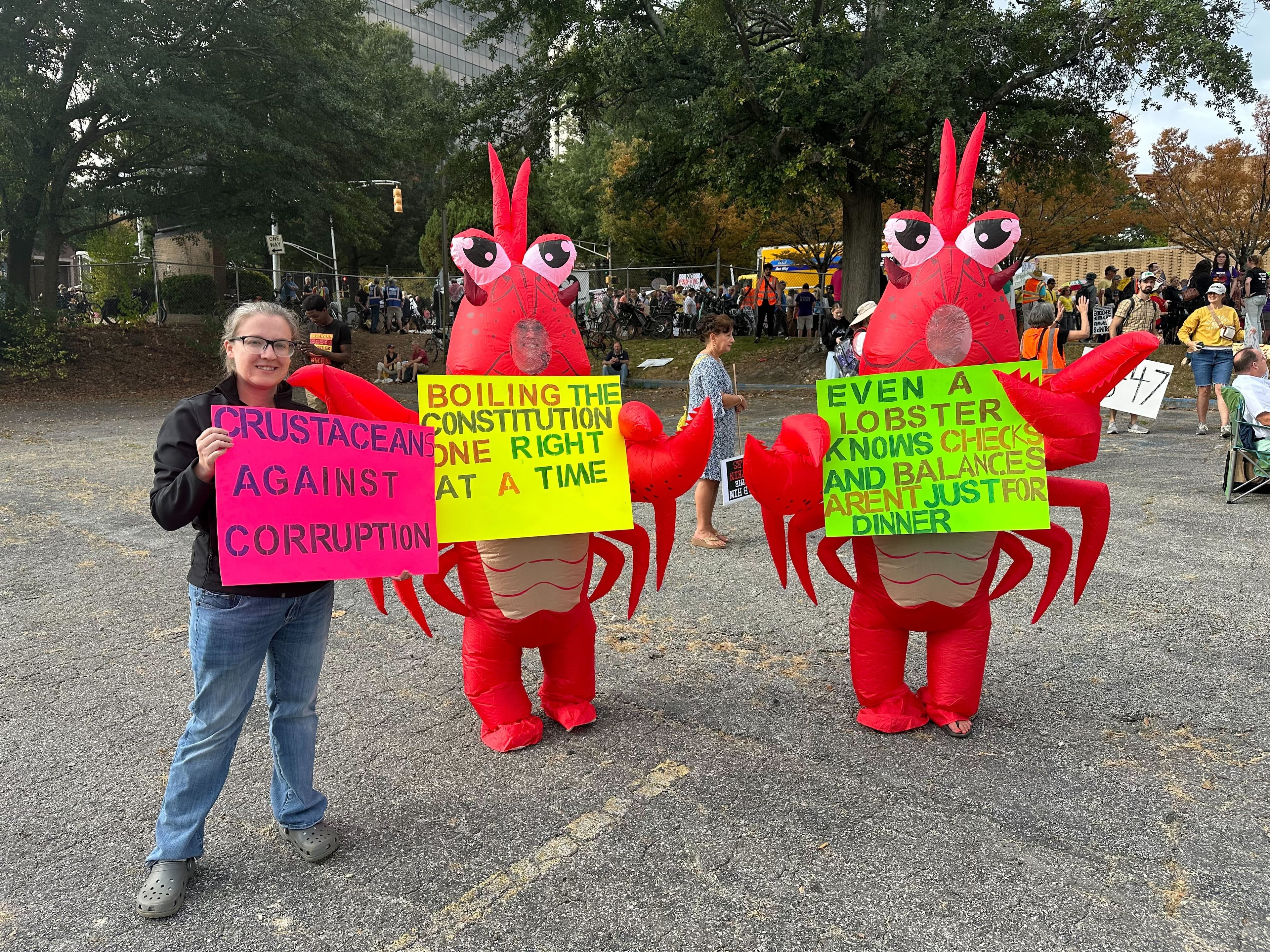 Two people dressed up a lobsters attended the Atlanta "No Kings" protest. They coined themselves as "Crustacean Against Corruption." (Amy Wenk /AJC)