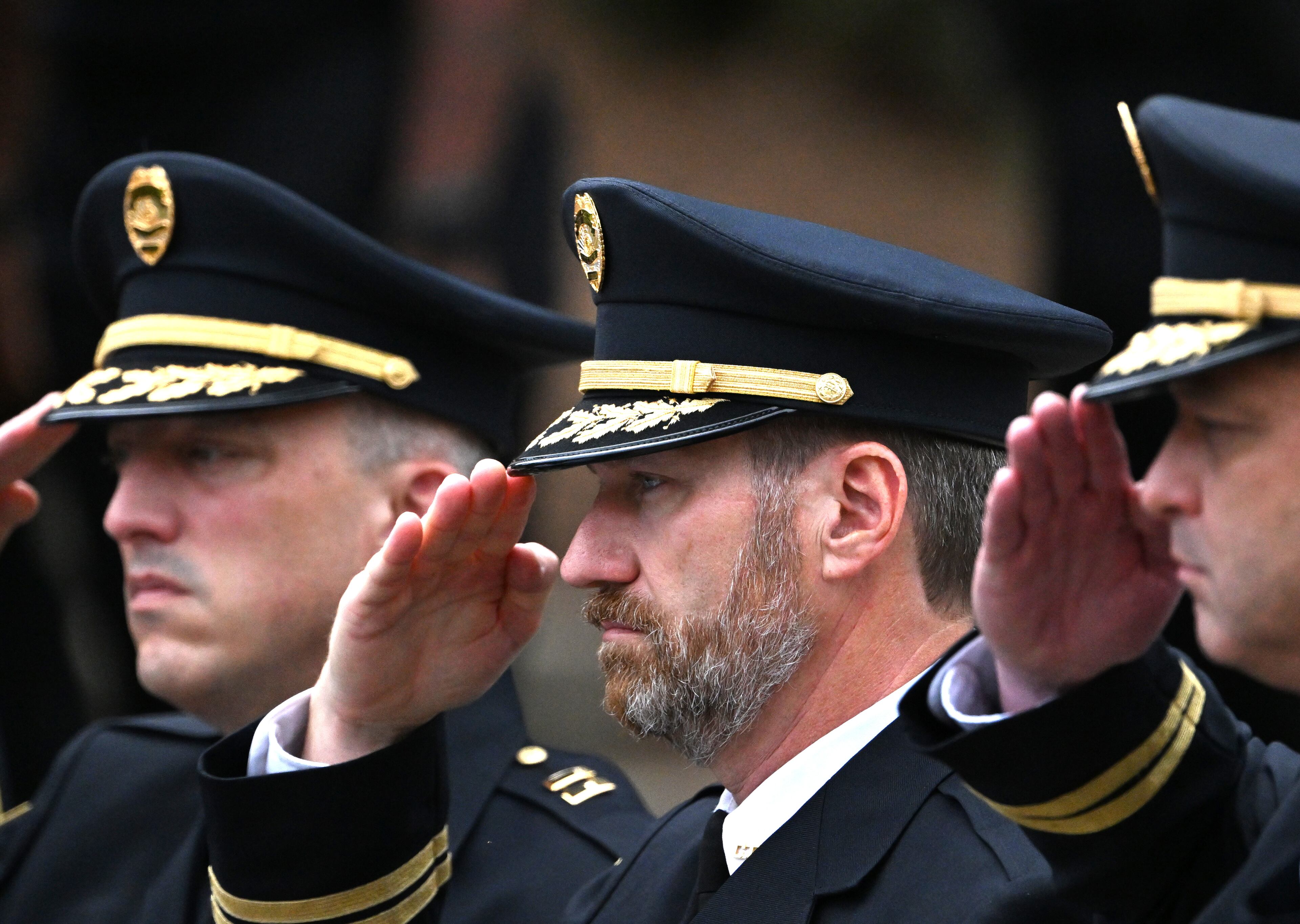 Members of various law enforcement agencies salute during the Final Honors following the memorial service for DeKalb County police Officer David Rose, who was killed while responding to the Aug. 8 shooting at the CDC, outside the First Baptist Church Atlanta, Friday, August 22, 2025, in Atlanta. Hyosub Shin / AJC)