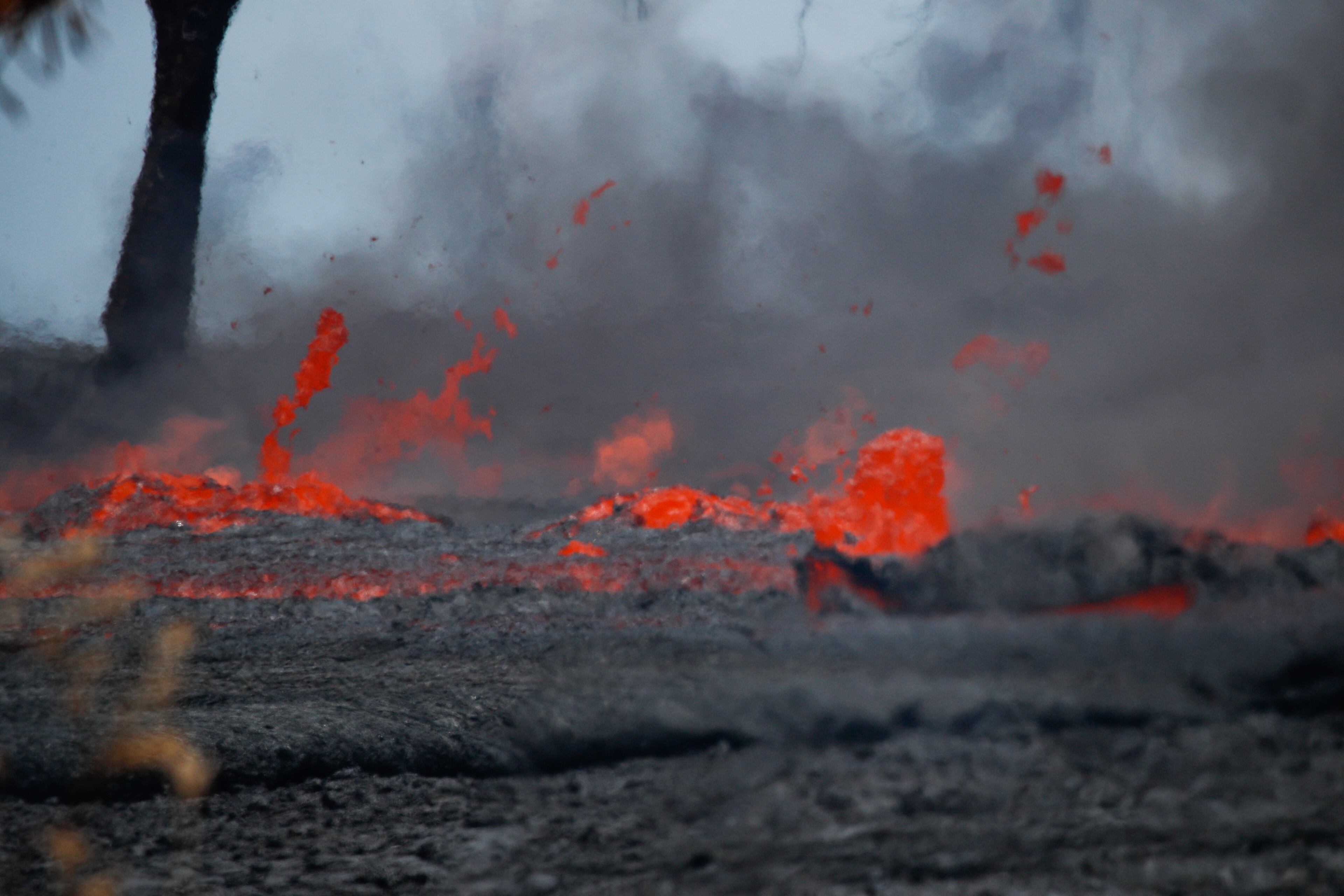 Fissures spew lava in the Leilani Estates subdivision near Pahoa, Hawaii, Tuesday, May 22, 2018. Authorities were racing Tuesday to close off production wells at a geothermal plant threatened by a lava flow from Kilauea volcano on Hawaii's Big Island. (AP Photo/Jae C. Hong)
