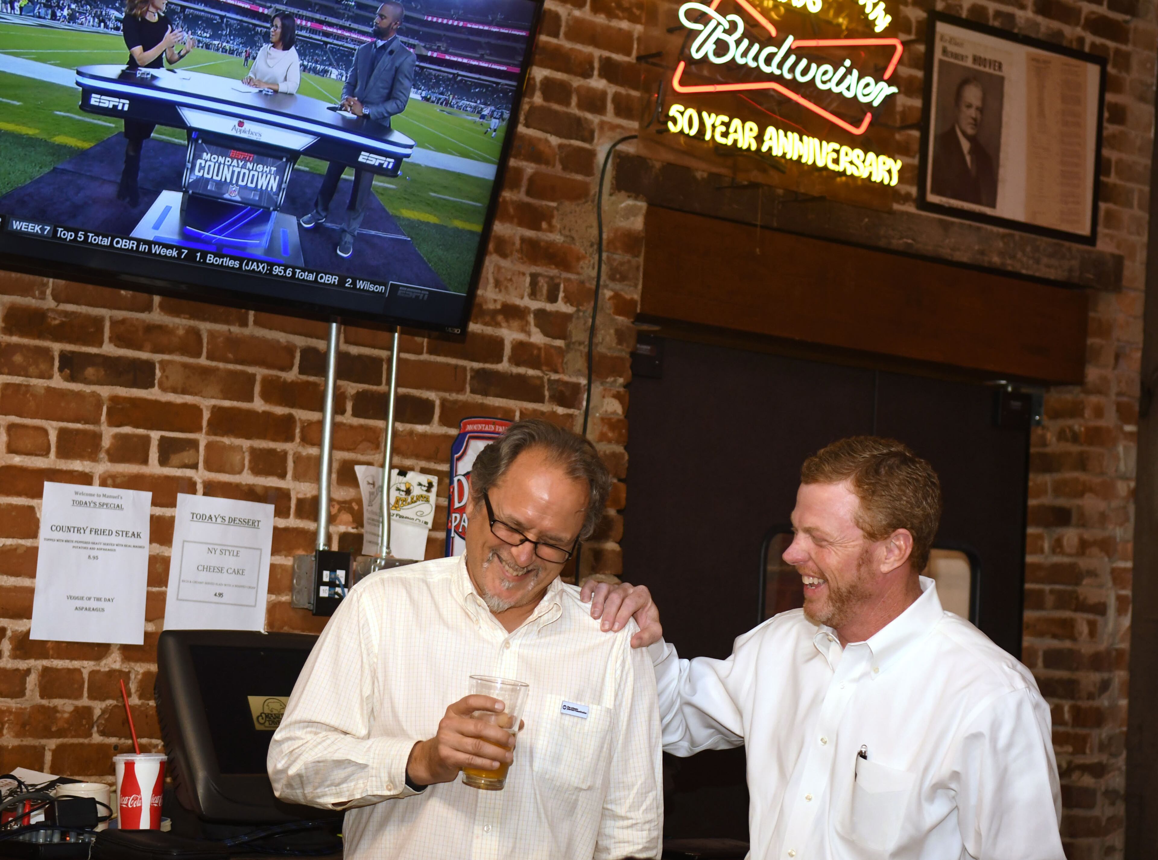 AJC's James Salzer (left) and Chris Riley (right) chat at the AJC's Politically Georgia's "Pressing for answers" at Manuel's Tavern in Atlanta on October 23, 2017. The event was sponsored by the Atlanta Journal-Constitution. (Rebecca Breyer)