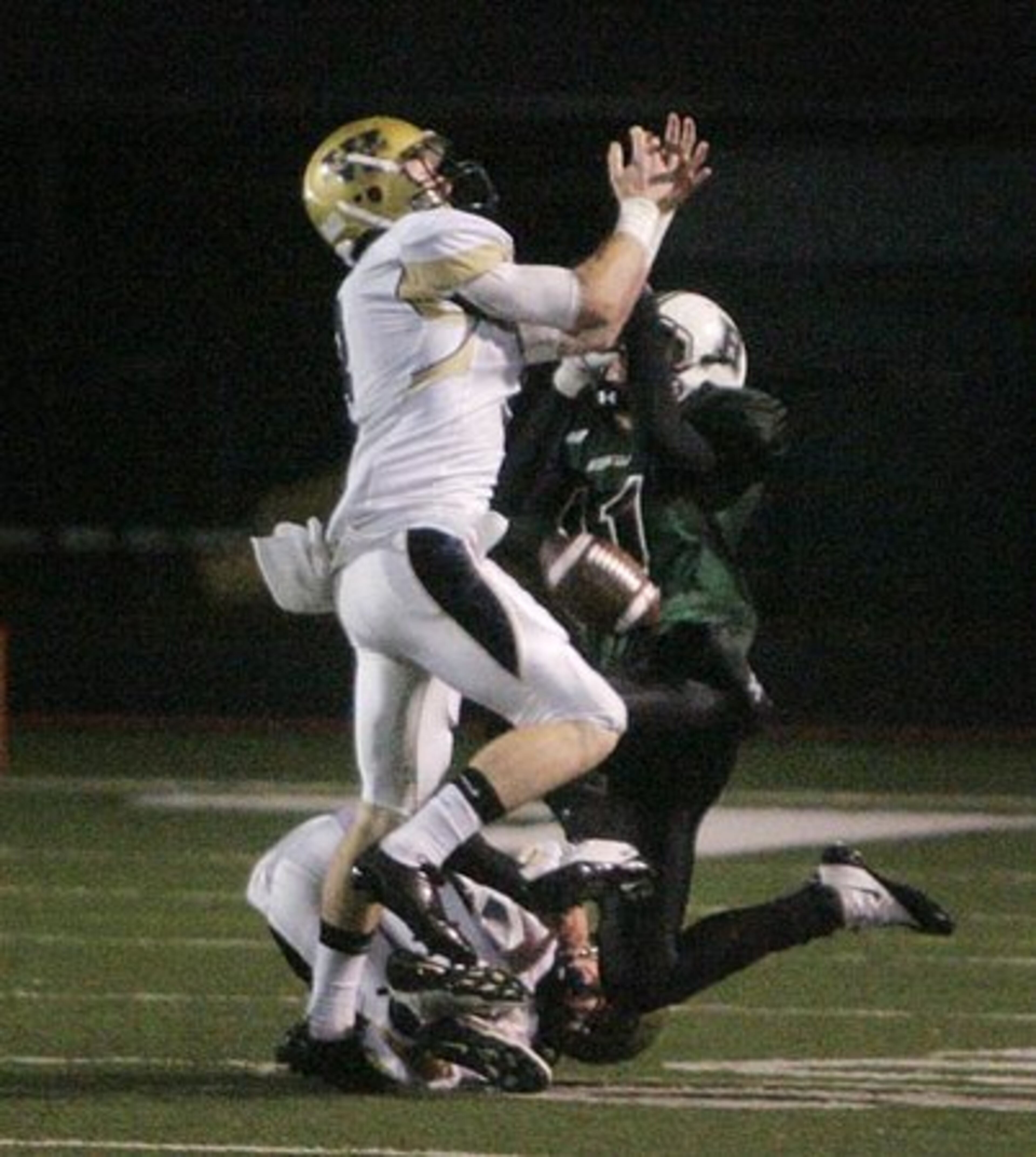 West Forsyth safety Trevor Guthrie, left, and Roswell wide receiver John Albert, right, vie for a pass.