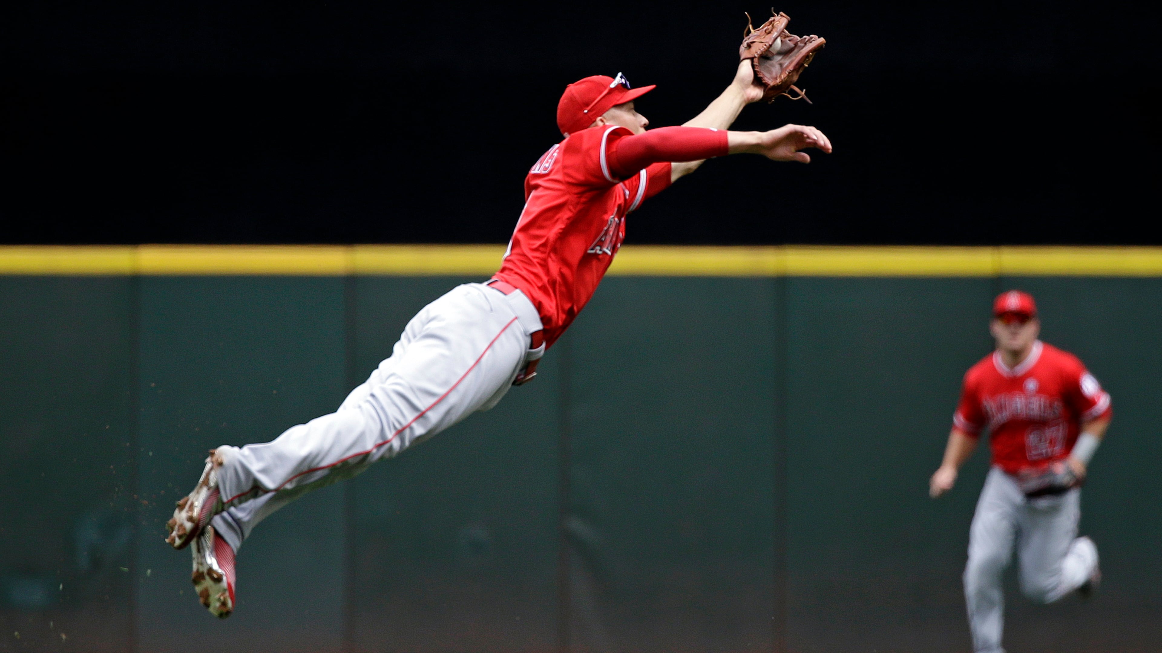 Los Angeles Angels shortstop Andrelton Simmons stretches as he snags a line drive by Seattle Mariners' Jean Segura in the first inning of a baseball game Sunday, Aug. 13, 2017, in Seattle. (AP Photo/Elaine Thompson)
