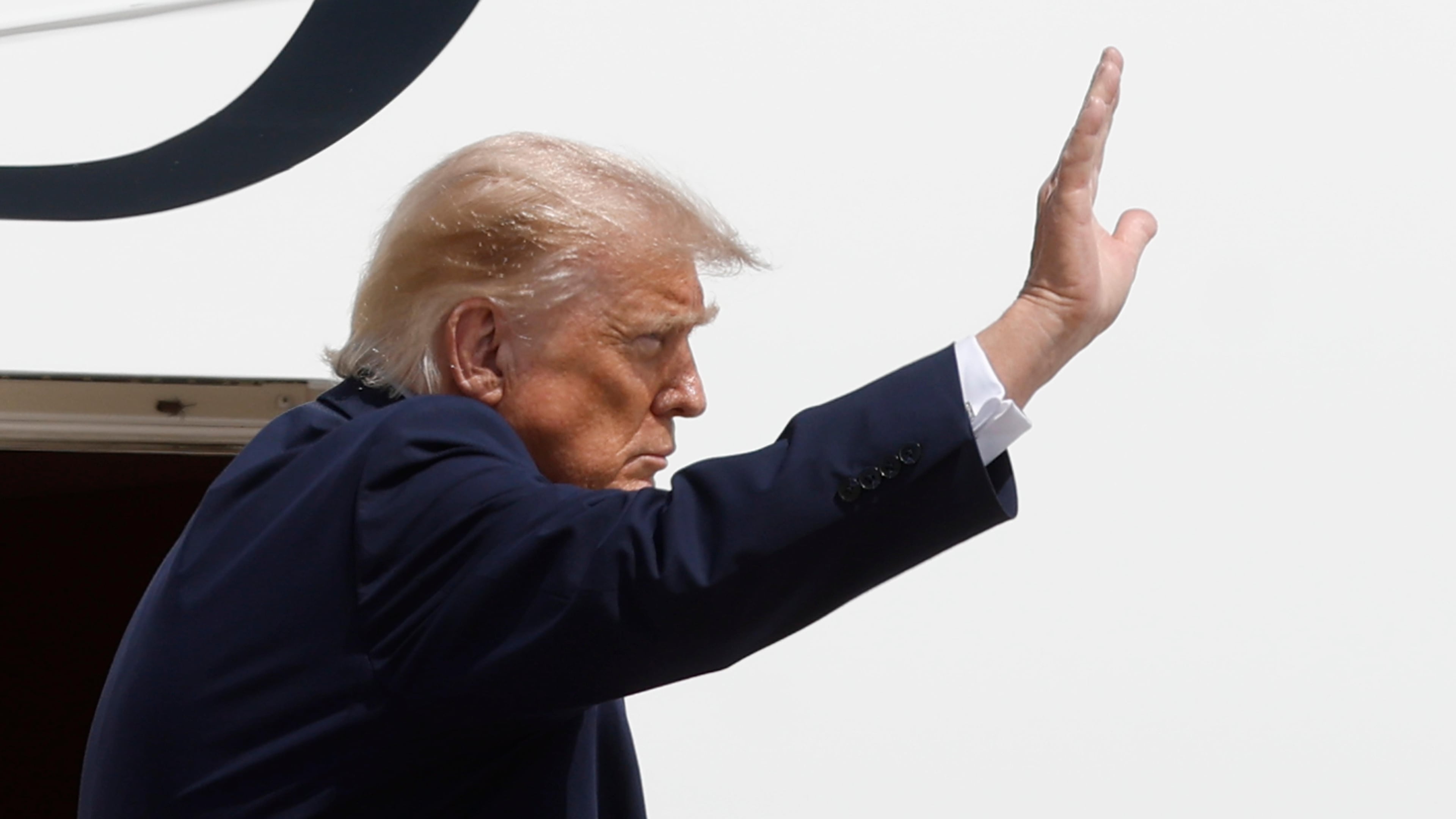 President Donald Trump waves from the stairs of Air Force One at Joint Base Andrews, Md., Tuesday, Aug. 4, 2026.(AP Photo/Luis M. Alvarez)