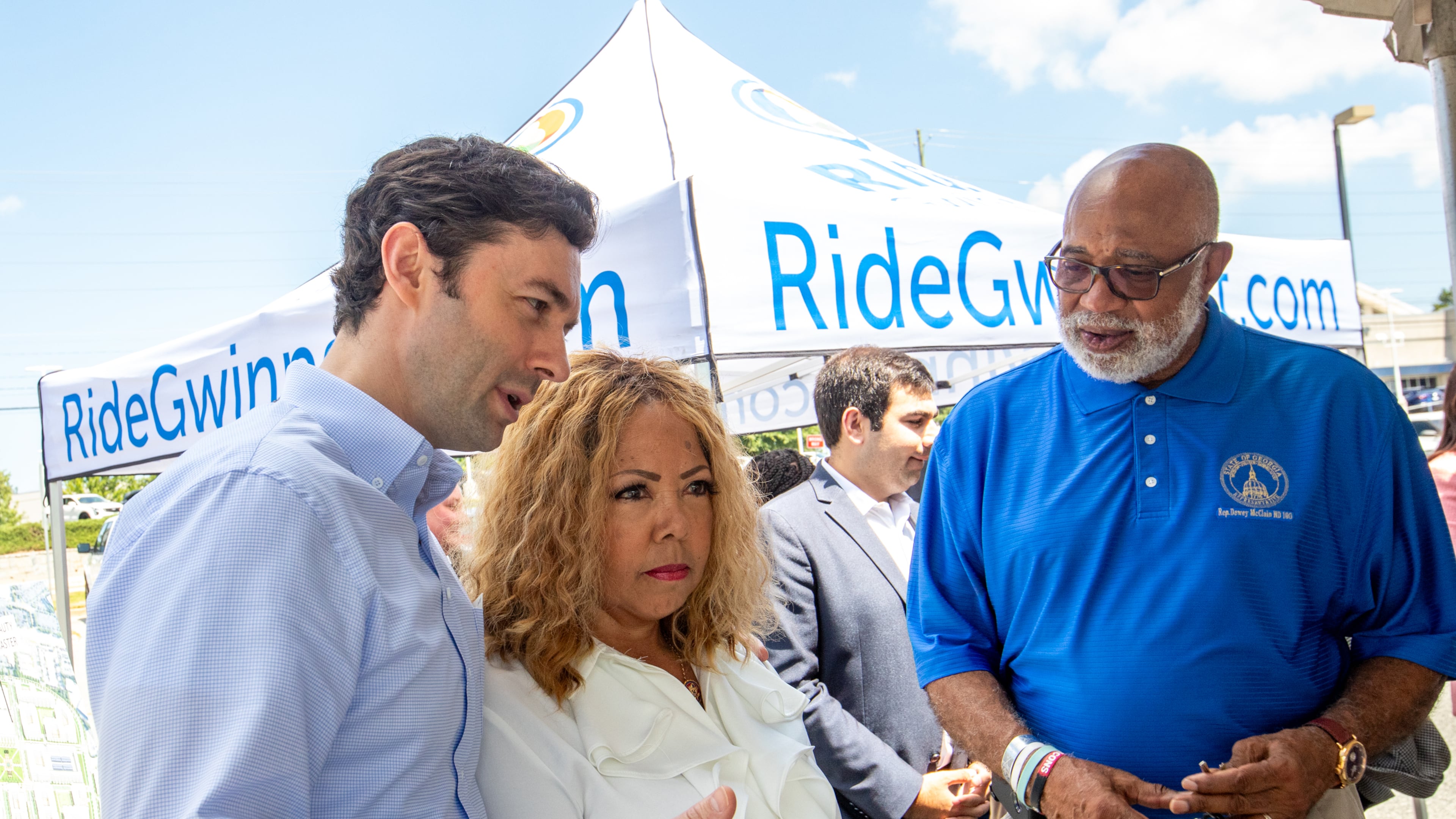 Senator Jon Ossoff, from left, and Congresswoman Lucy McBath talk before greeting Georgia State House Representative Dewey McClain, right, at the Gwinnett County celebration of a $20 million grant Monday, July 24, 2023 awarded by the federal government to transform the transit center just west of Gwinnett Place Mall. (Jenni Girtman for The Atlanta Journal-Constitution)