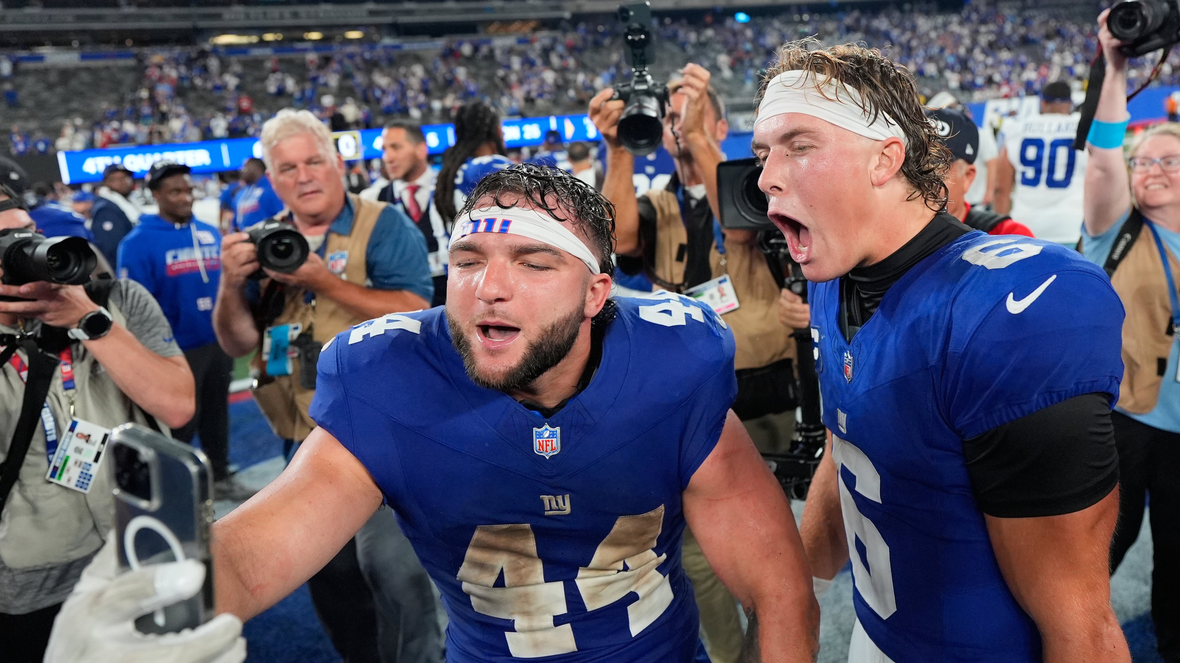 New York Giants running back Cam Skattebo (44) and quarterback Jaxson Dart (6) react with a cell phone following an NFL football game against the Dallas Cowboys Sunday, Sept. 13, 2026, in East Rutherford, N.J. (AP Photo/Yuki Iwamura)