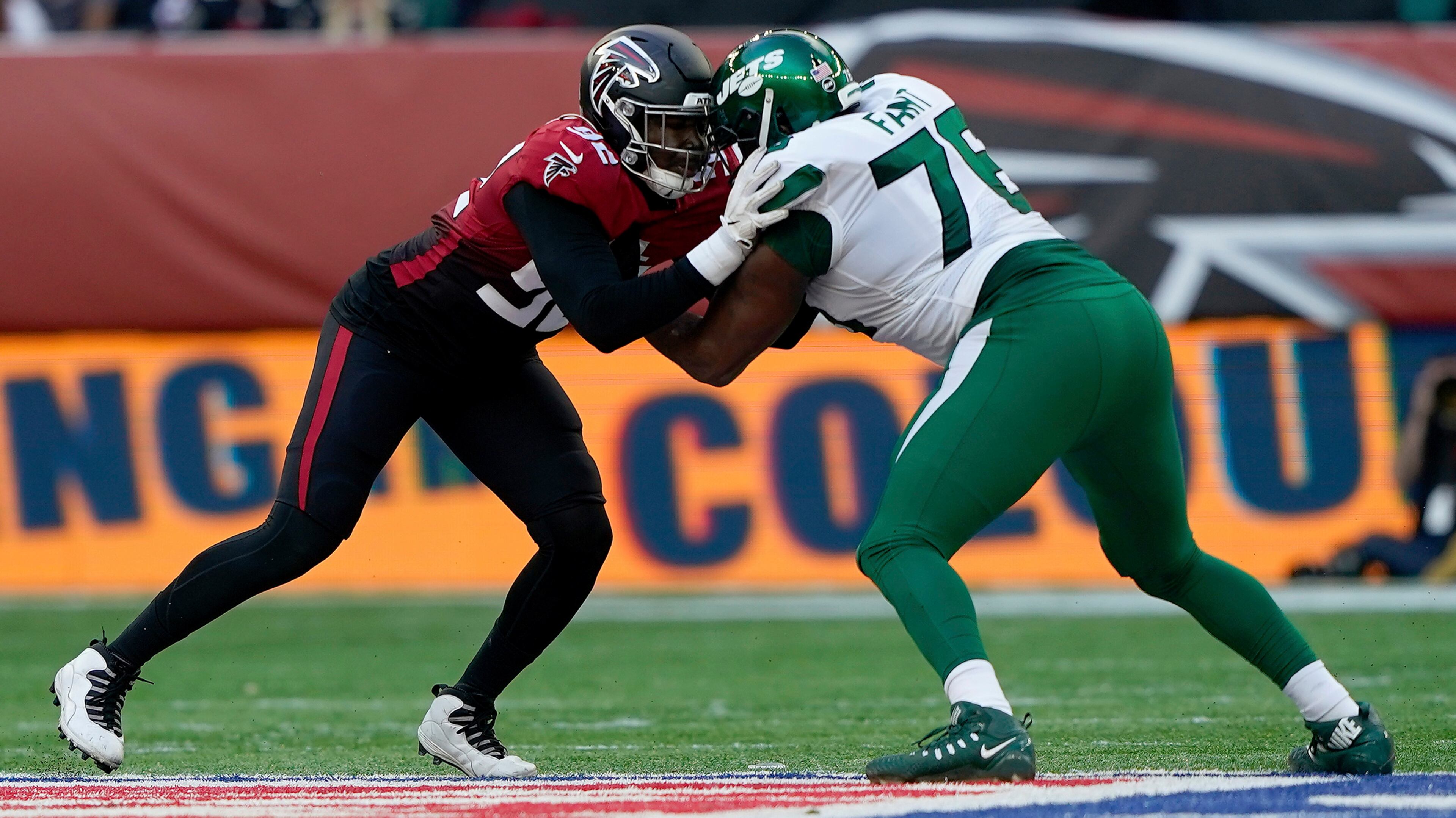 Falcons linebacker Adetokunbo Ogundeji (92) locks up with New York Jets offensive tackle George Fant (76) Sunday, Oct. 10, 2021, at Tottenham Hotspur Stadium in London. The Falcons won 27-20. (Steve Luciano/AP)