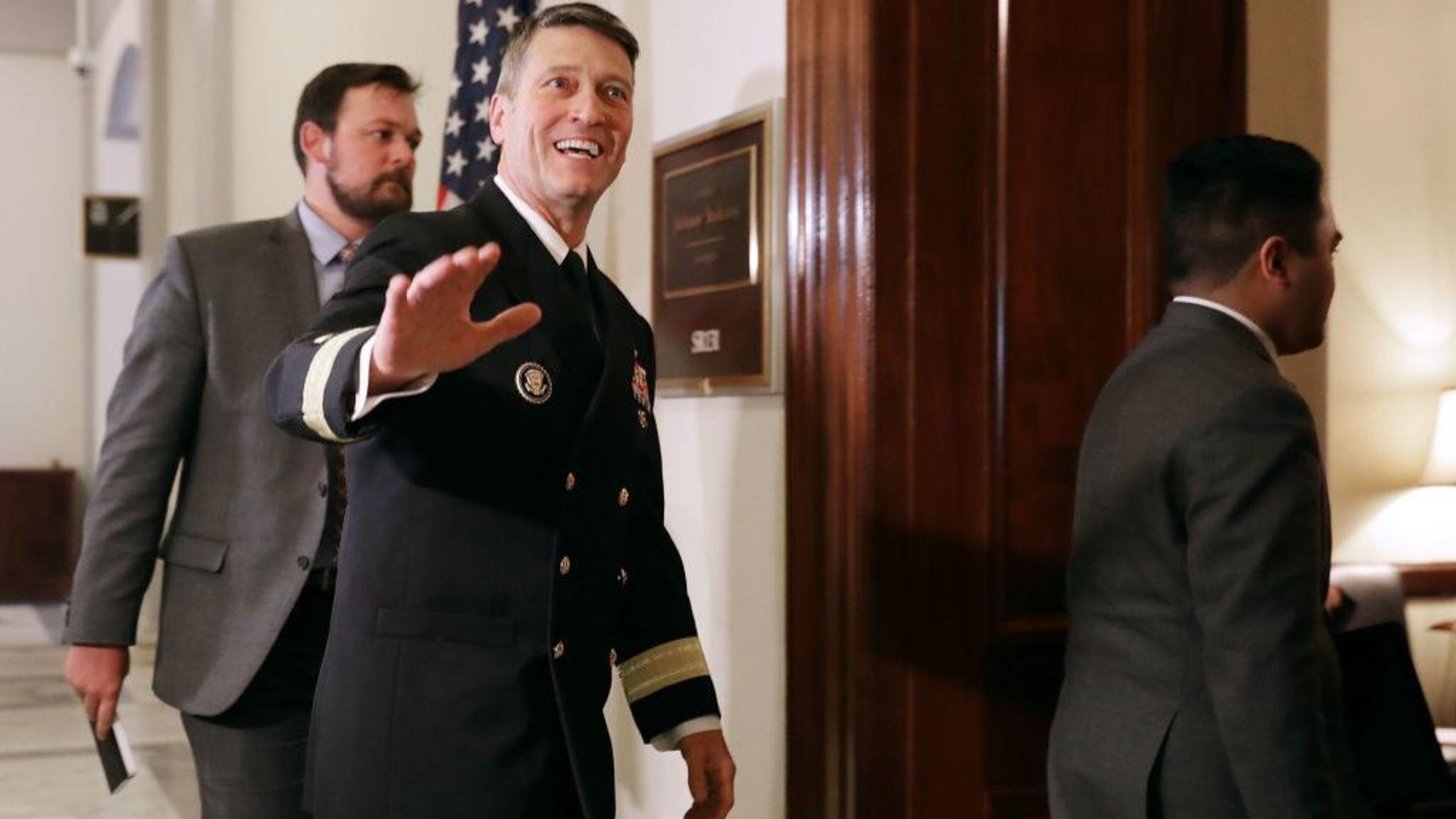 Physician to the president U.S. Navy Rear Admiral Ronny Jackson waves to journalists as he heads into a meeting with Senate Veterans Affairs Committee Chairman Johnny Isakson (R-GA) in the Russell Senate Office Building on Capitol Hill April 16, 2018 in Washington, DC.