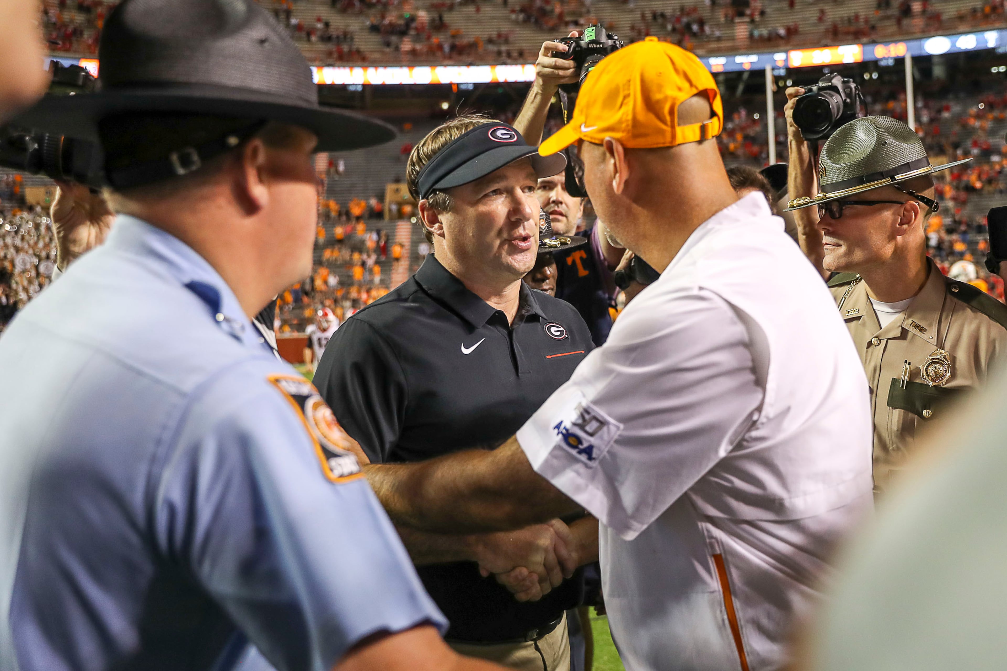 Georgia Bulldogs head coach Kirby Smart and Tennessee Volunteers head coach Jeremy Pruitt speak following the game. (Alyssa Pointer/Atlanta Journal Constitution)
