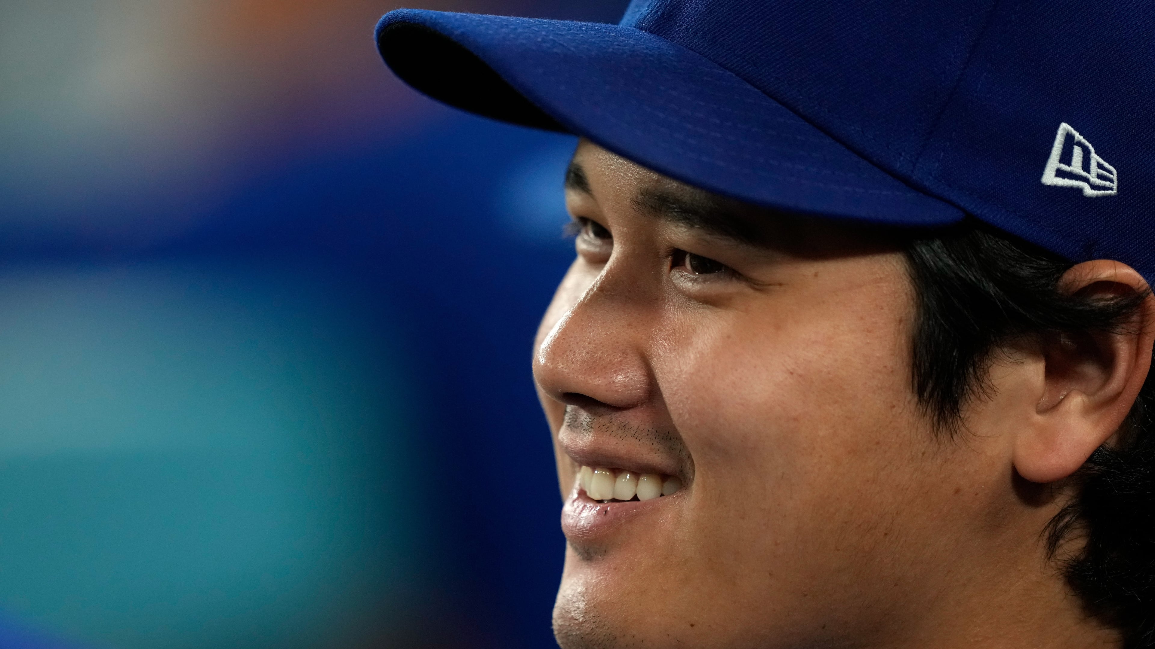 Los Angeles Dodgers' Shohei Ohtani smiles as he sits in the dugout during the eighth inning of a baseball game against the San Diego Padres, Tuesday, Sept. 22, 2026, in Los Angeles. (AP Photo/Mark J. Terrill)