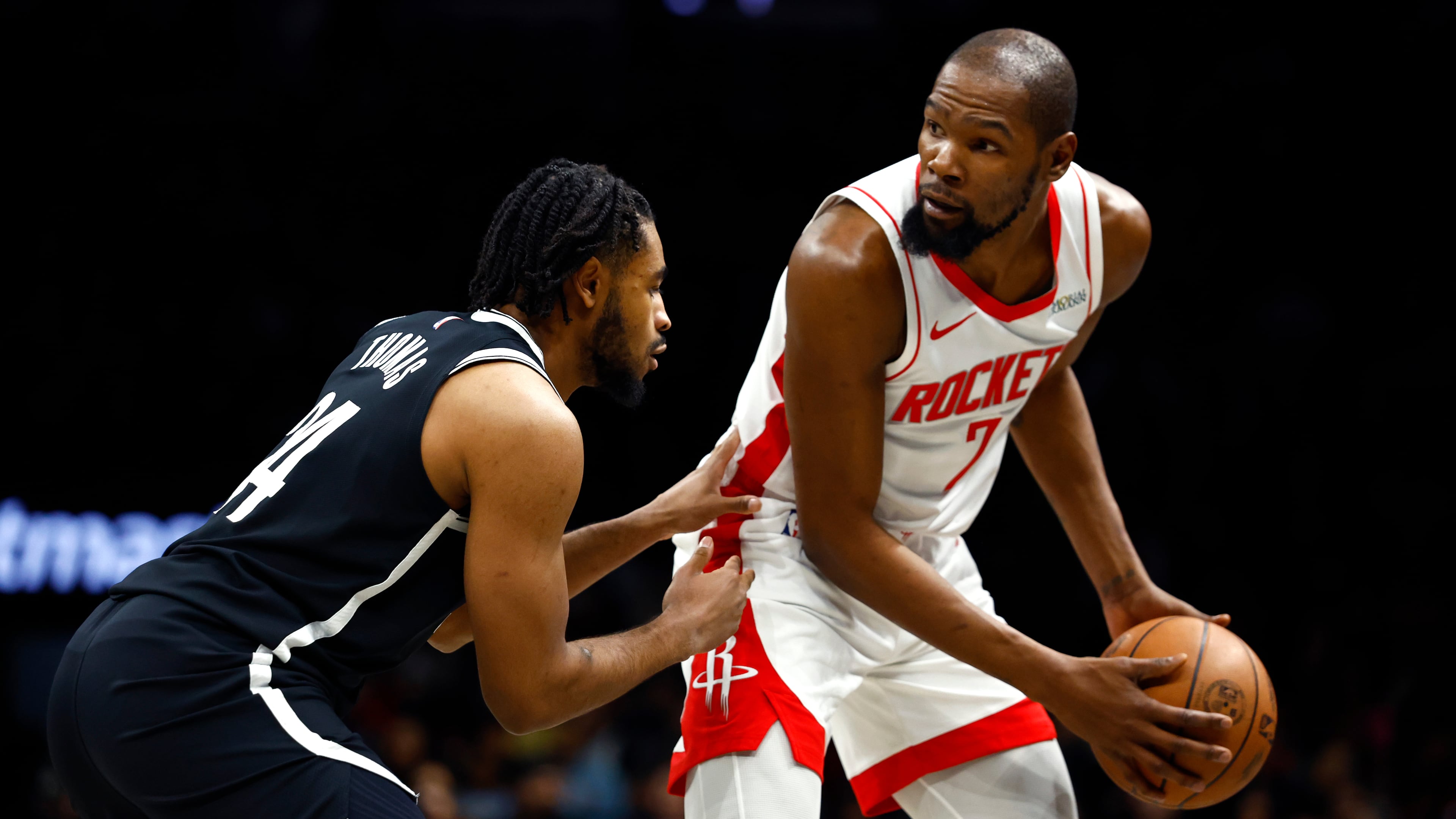 Houston Rockets forward Kevin Durant (7) handles the ball against Brooklyn Nets guard Cam Thomas, left, during the first half of an NBA basketball game, Thursday, Jan. 1, 2026, in New York. (AP Photo/Noah K. Murray)