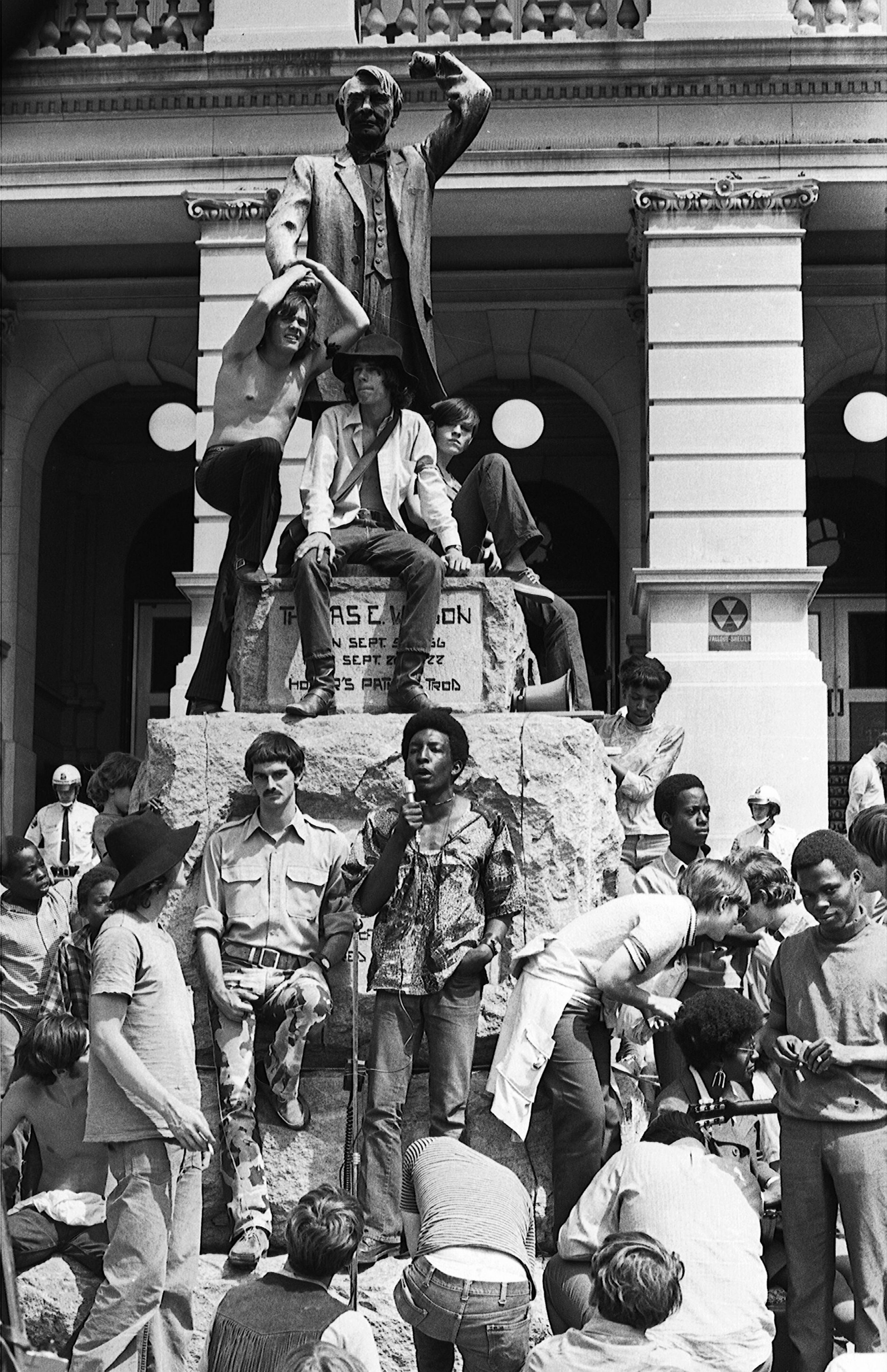 Speaking in front of the bronze statue of Tom Watson that once stood on the lawn of the Georgia State Capitol, Atlanta Black Panther member Tim Haynes (top left) denounces the “pig power structure” during an anti-Vietnam war rally in May 1970.