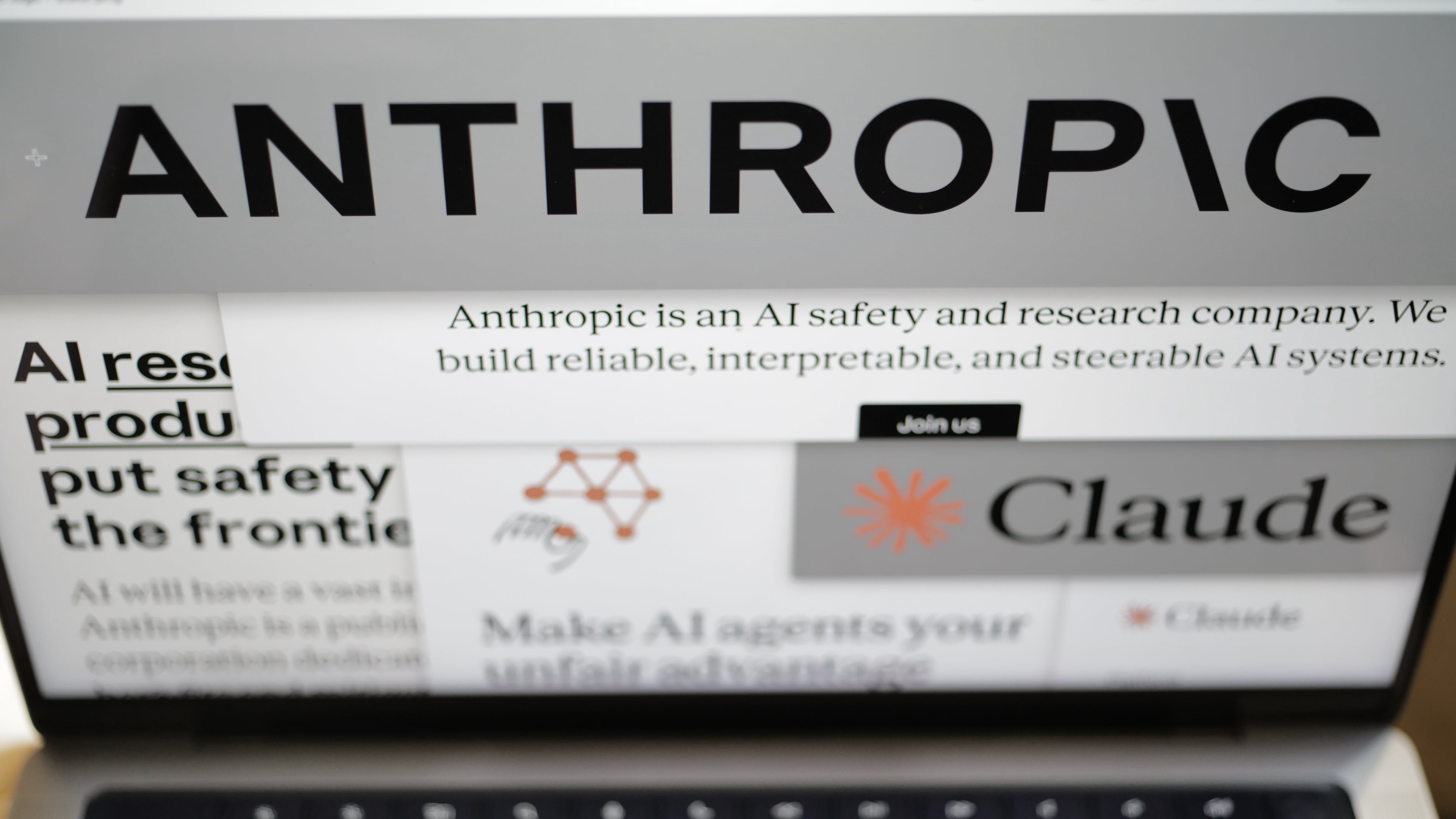 Pages from the Anthropic website and the company's logos are displayed on a computer screen in New York on Thursday, Feb. 26, 2026. (AP Photo/Patrick Sison)