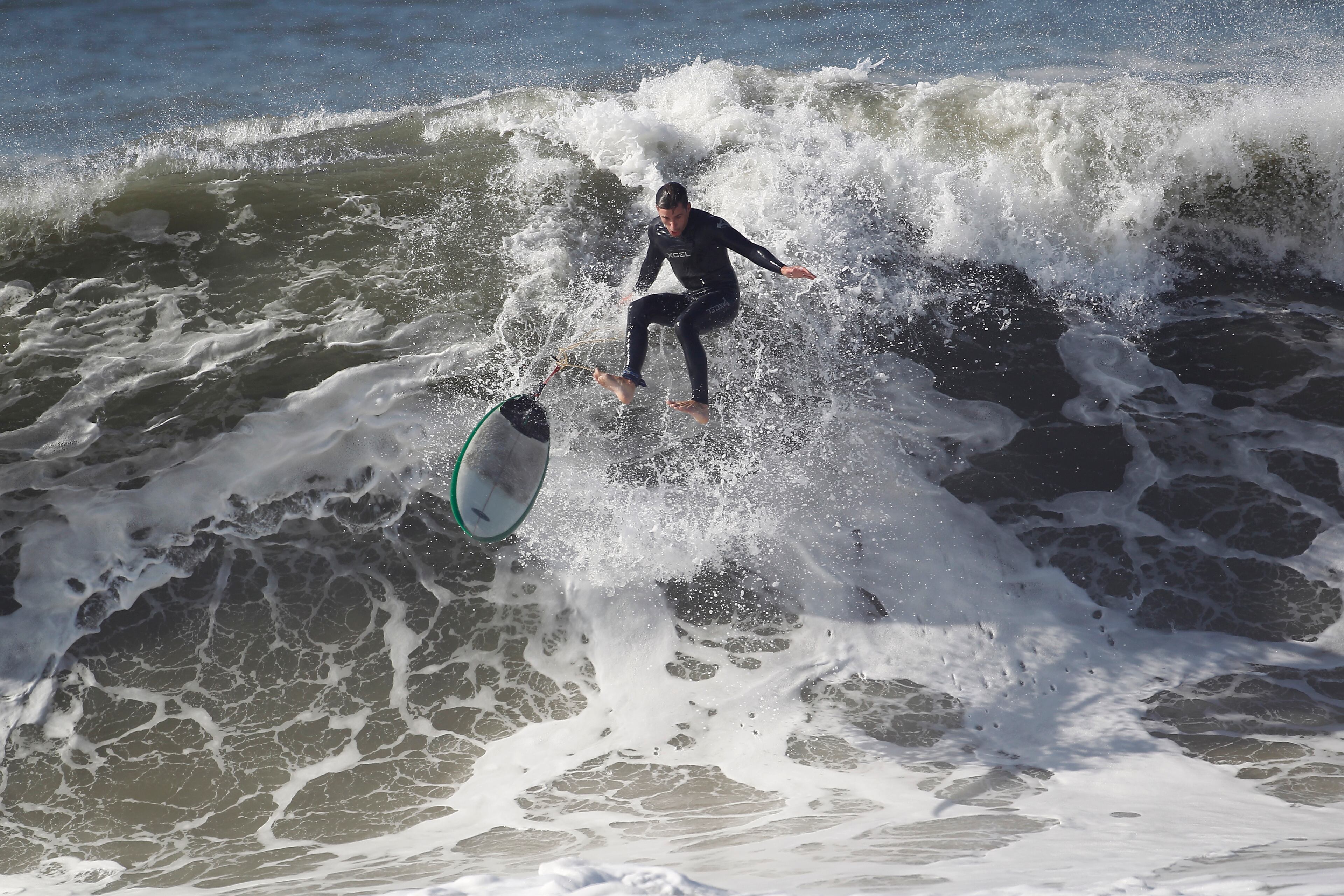 A surfer wipes out from a large wave at Seal Beach on Wednesday, Aug. 27, 2014. The National Weather Service said beaches stretching 100 miles up the Southern California coast would see large waves and rip currents. Swimmers and surfers were urged to be aware of the dangerous conditions. (AP Photo/ Nick Ut )