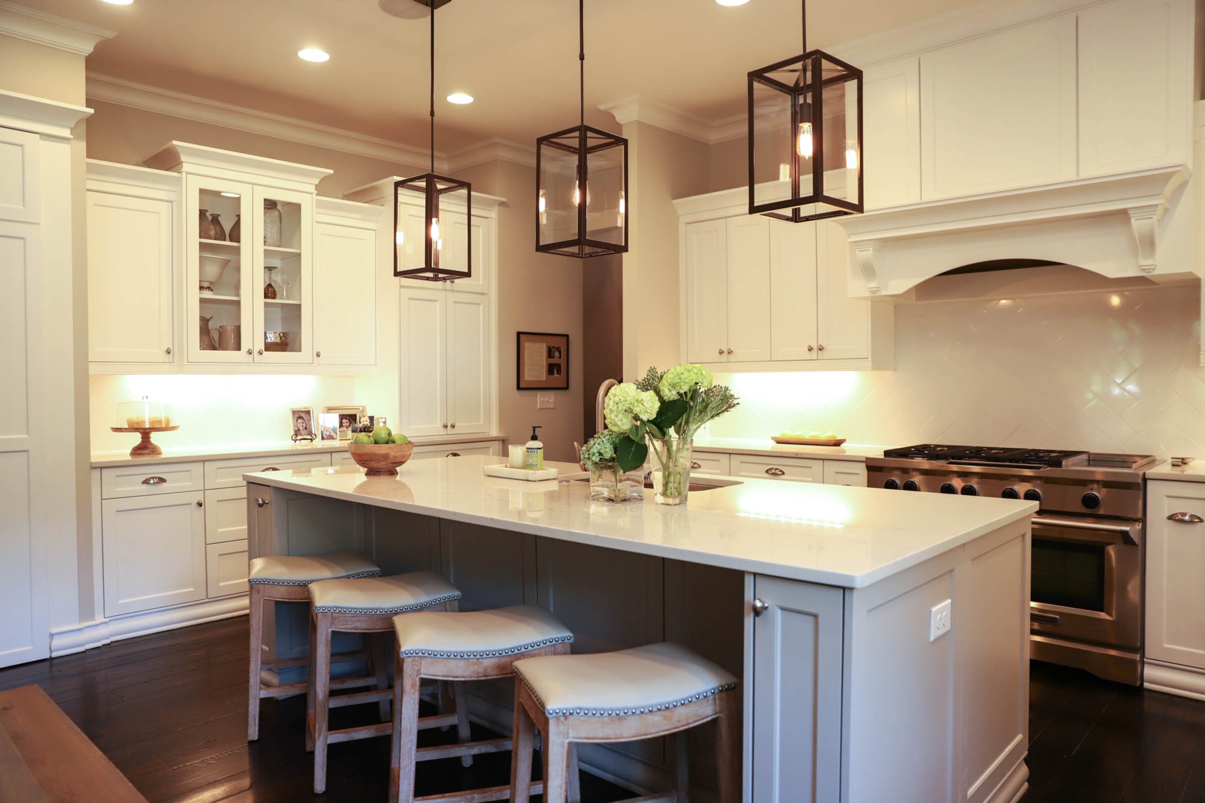 Pendant lights from Progressive Lighting contrast with the light and airy style of the kitchen, while stools from Grandin Road provide a bit of traditional style. The island and kitchen table provide great places to gather. "With the openness of it, it's really easy for all of us to be there, to have company over, communication is very easy," said Schwartz.