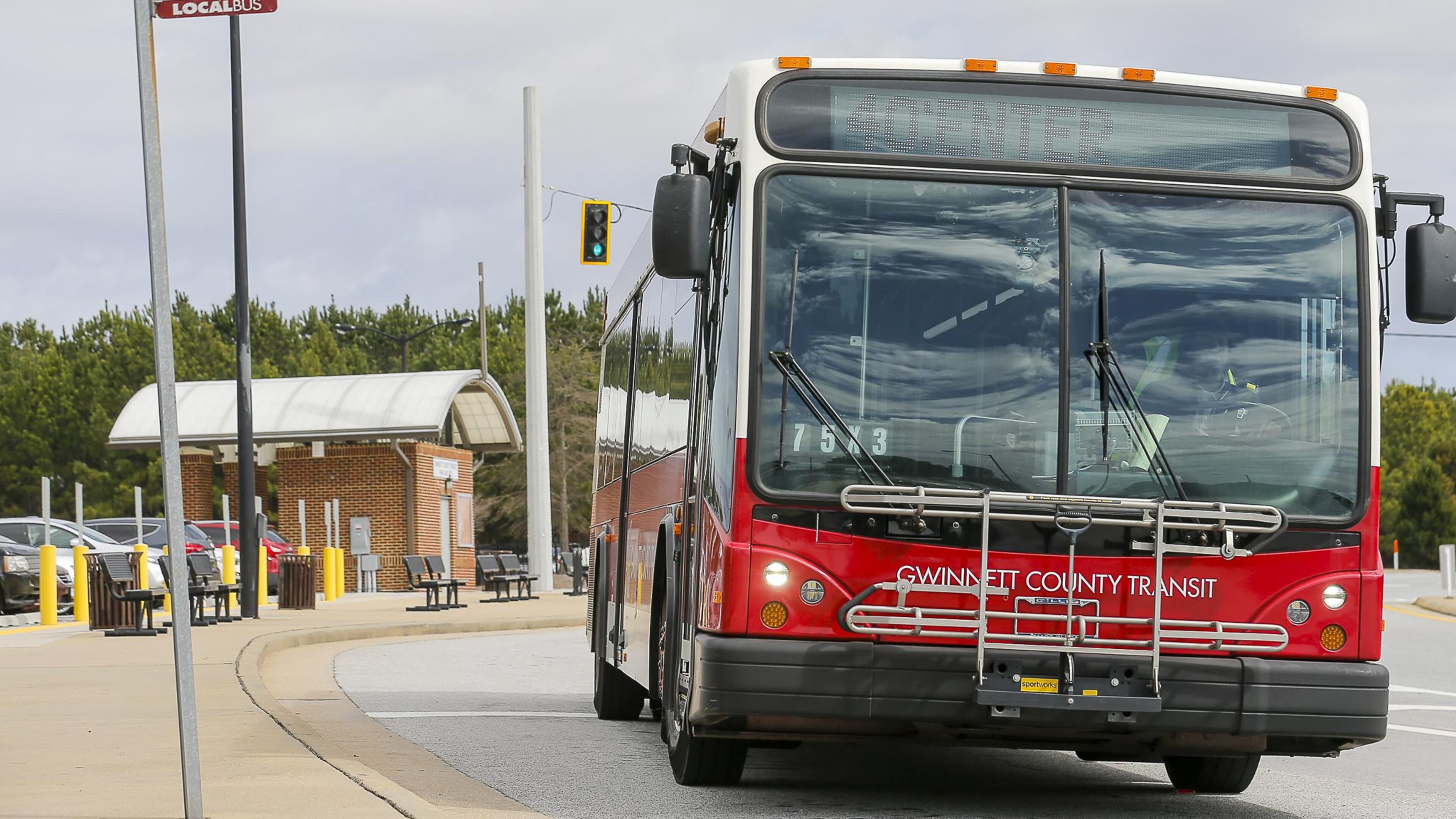 A Gwinnett County Transit bus travels along North Brown Road NW near a Gwinnett County Transit Park and Ride bus station in Lawrenceville. (ALYSSA POINTER/ALYSSA.POINTER@AJC.COM) AJC FILE PHOTO