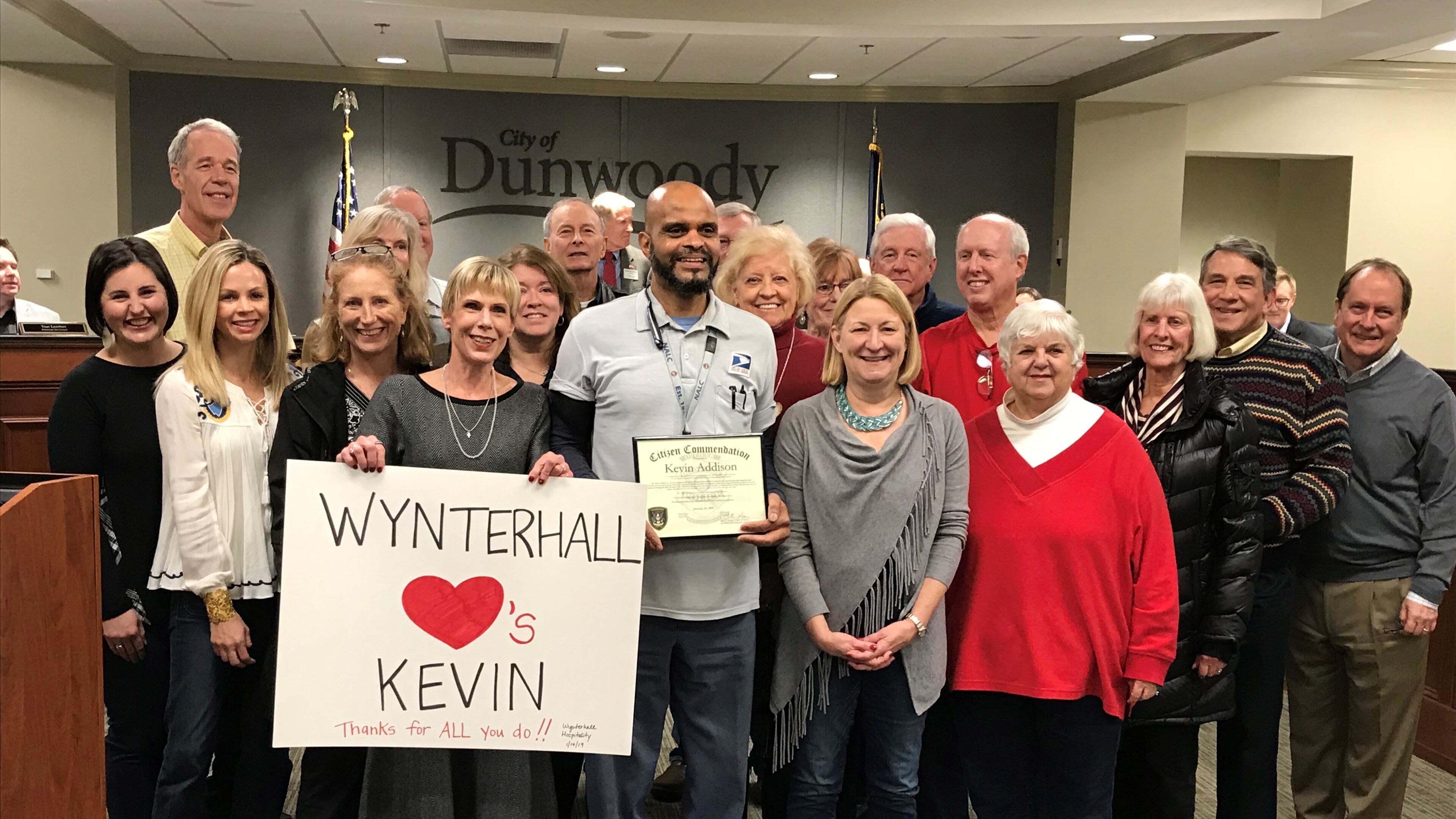 The city of Dunwoody honored mail carrier Kevin Addison (center) after he aided police in catching an identify fraud suspect.