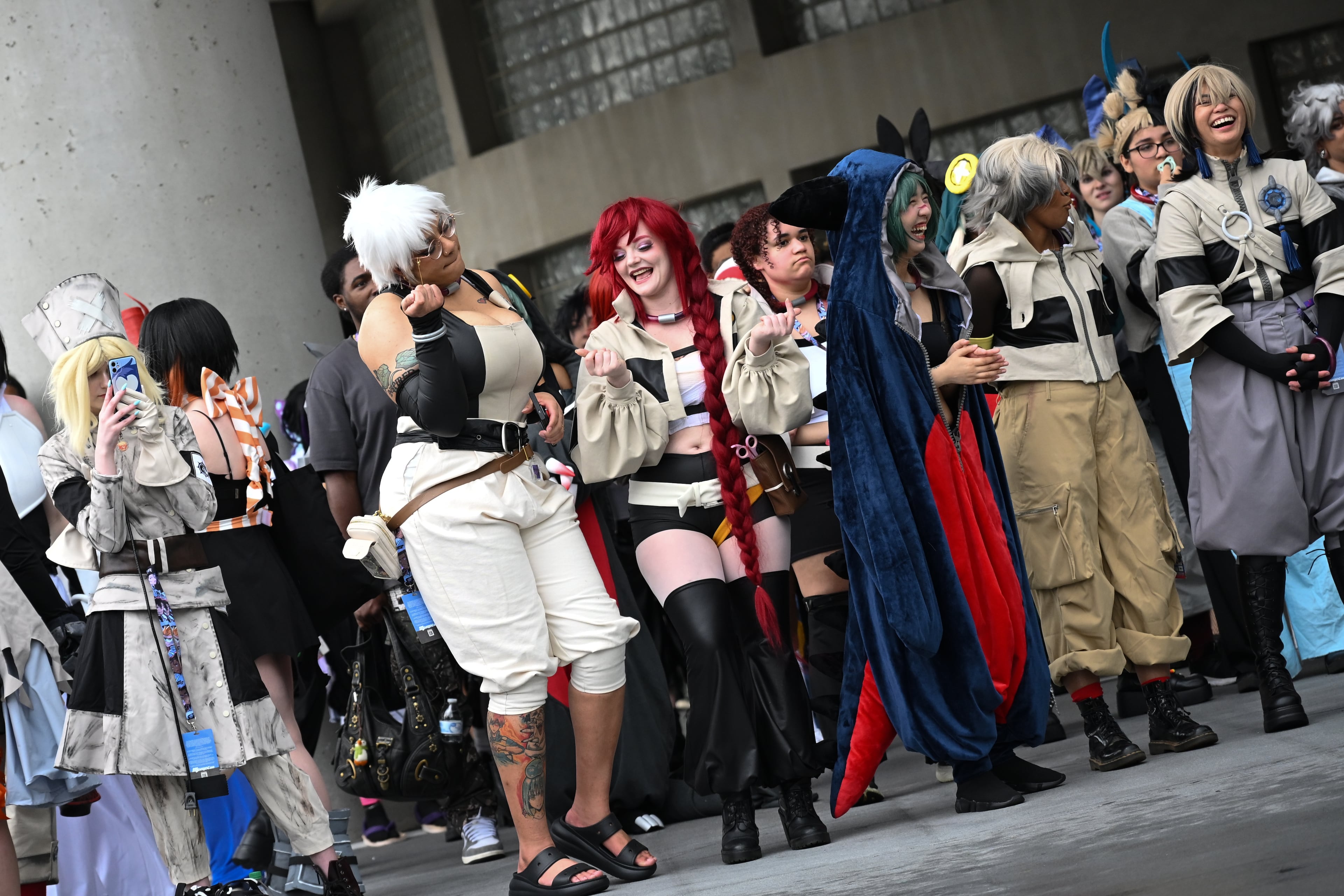 Attendees watch and cheer for a photoshoot during MomoCon at the Georgia World Congress Center in Atlanta on Friday, May 22, 2026. (Tyler Sun for the AJC)