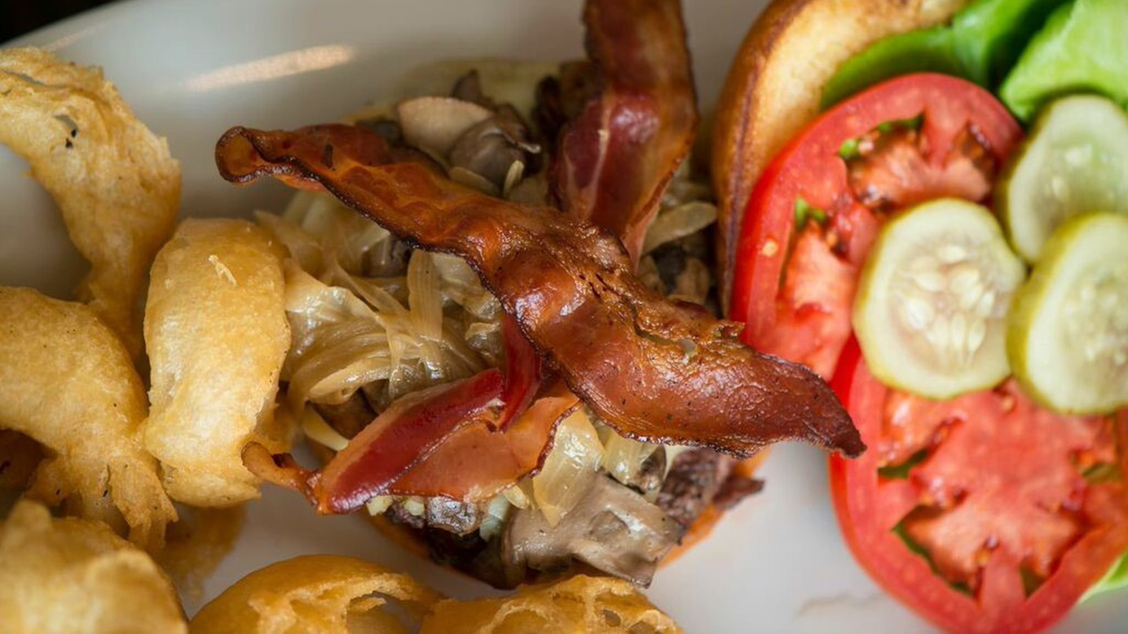 With a juicy patty, perfectly crisped bacon, two cheeses and a thick onion ring, the BCB burger at Peach & the Porkchop didn’t need a single condiment. (George Miko)
