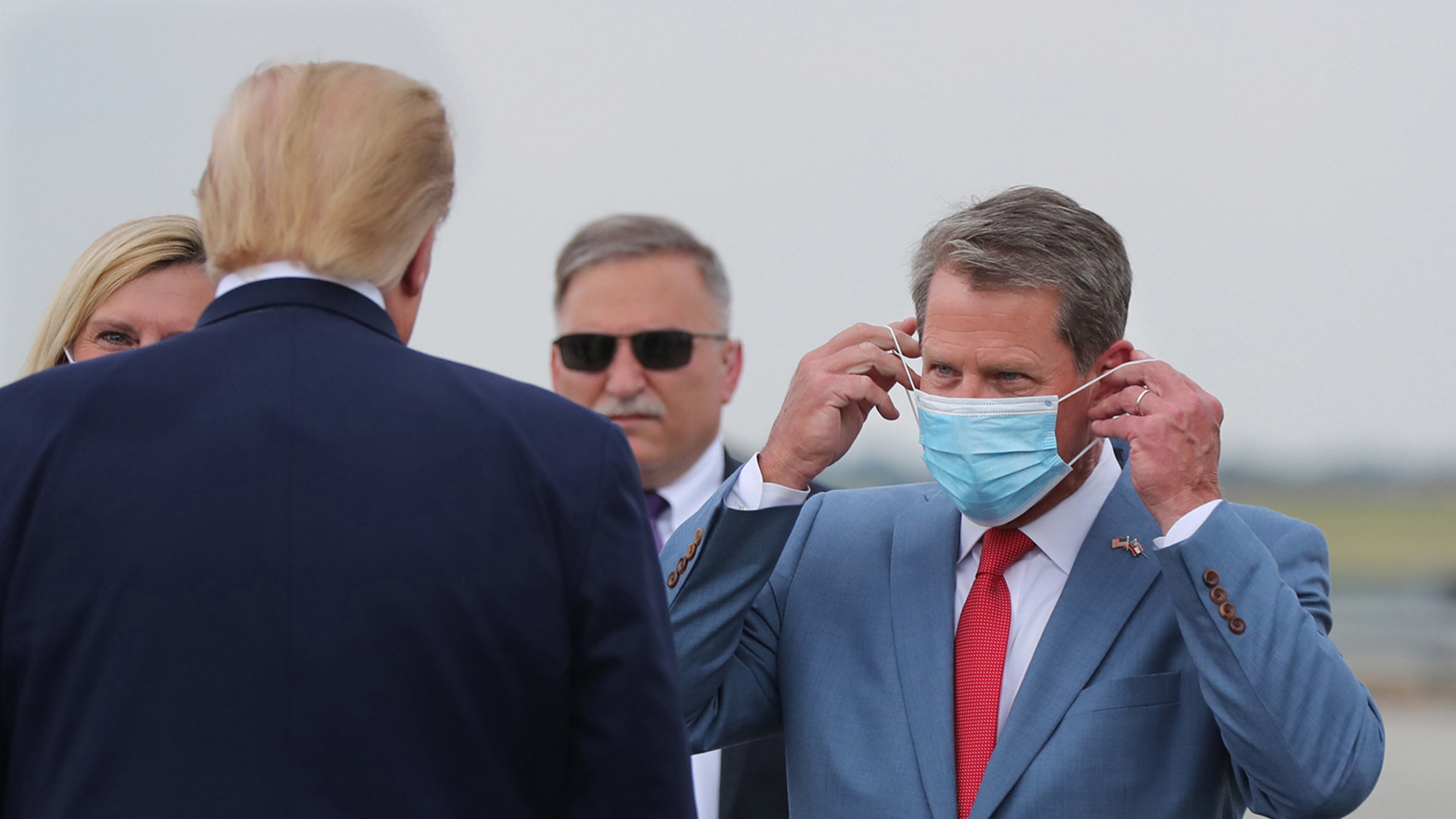 Georgia Gov. Brian Kemp, right, greets President Donald Trump as he visits Georgia to talk about an infrastructure overhaul at Hartsfield-Jackson International Airport in Atlanta on July 15, 2020. (Curtis Compton/Atlanta Journal-Constitution/TNS)