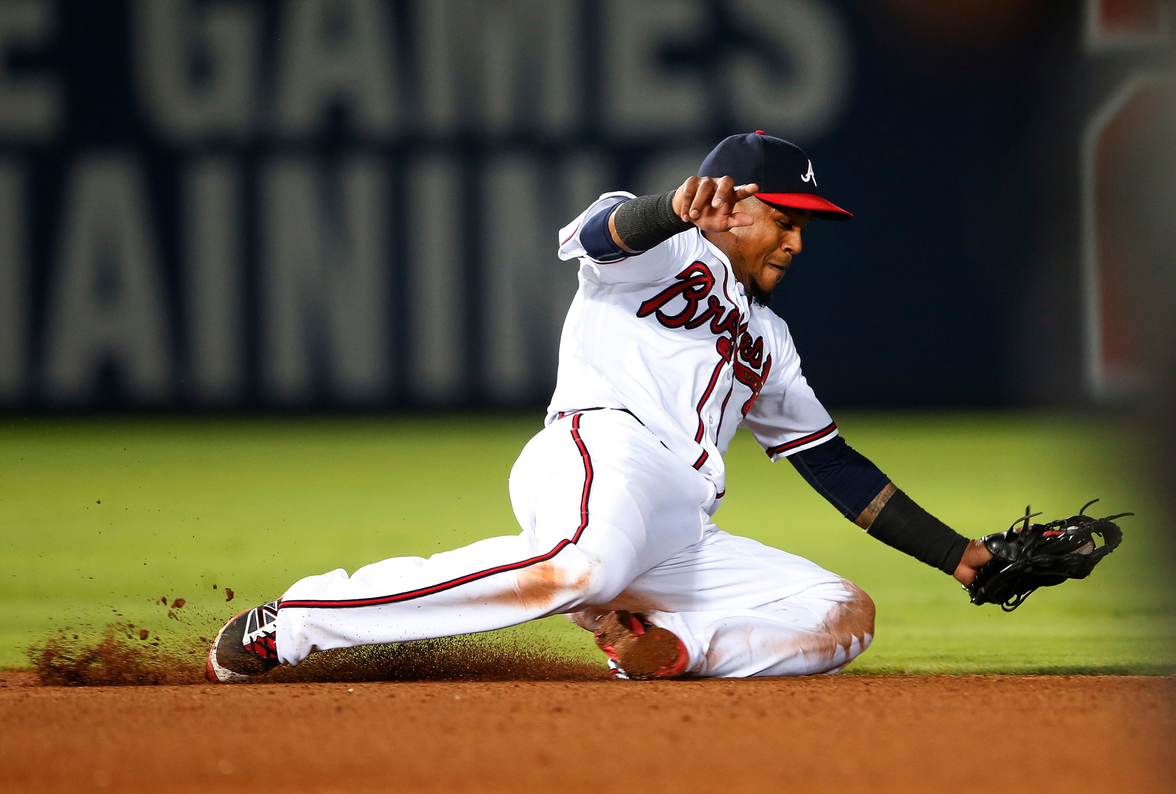 Atlanta Braves shortstop Erick Aybarmakes play on a ground ball by Philadelphia Phillies' Cesar Hernandez during the seventh inning of a baseball game Friday, July 29, 2016, in Atlanta. Hernandez was out at first base. (AP Photo/John Bazemore)