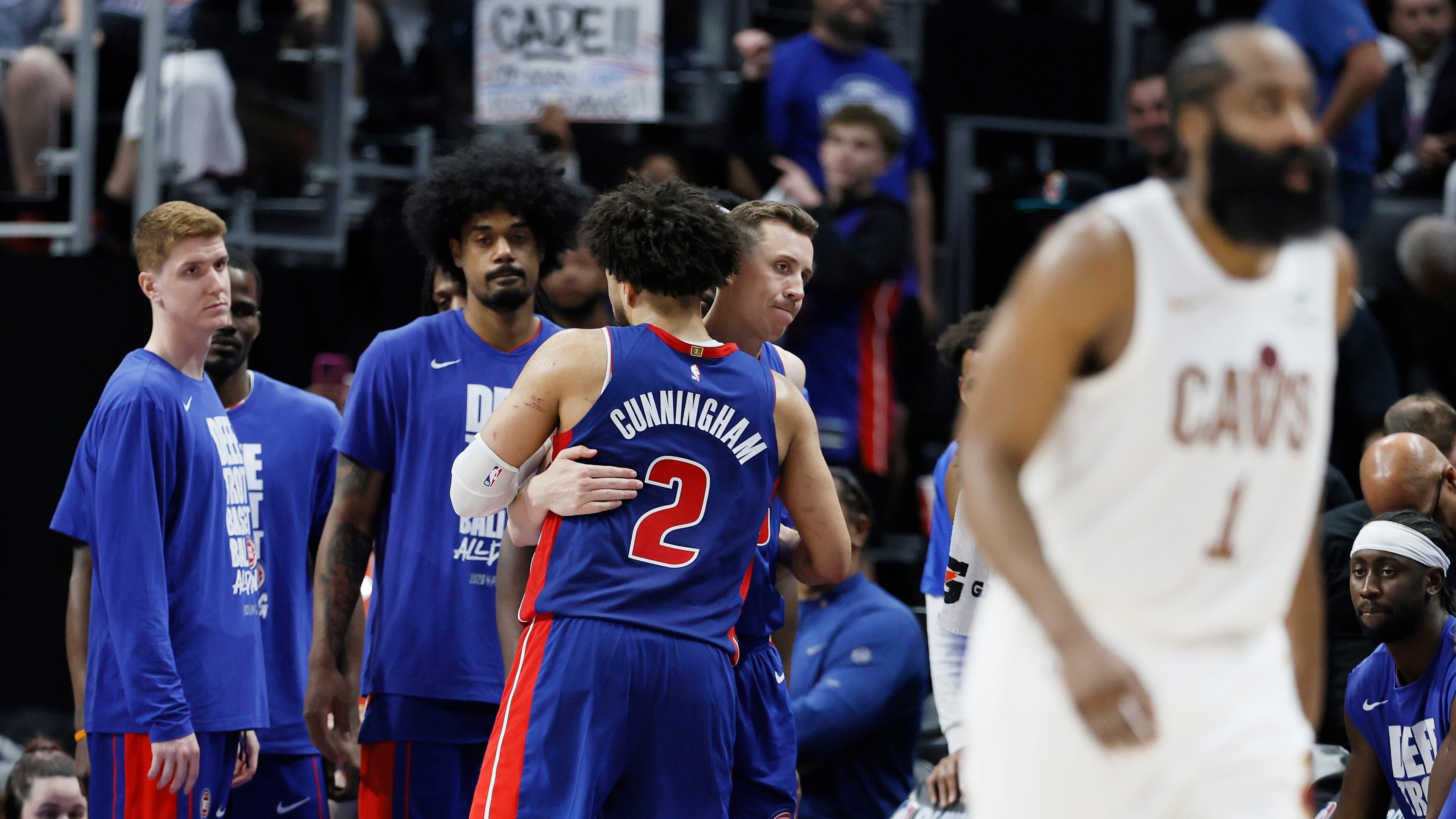 Detroit Pistons guard Cade Cunningham (2) is hugged by Duncan Robinson as Kevin Huerter, left, and Tolu Smith wait late in the fourth quarter of a loss to the Cleveland Cavaliers during Game 7 in a second-round NBA basketball playoffs series Sunday, May 17, 2026, in Detroit. (AP Photo/Duane Burleson)