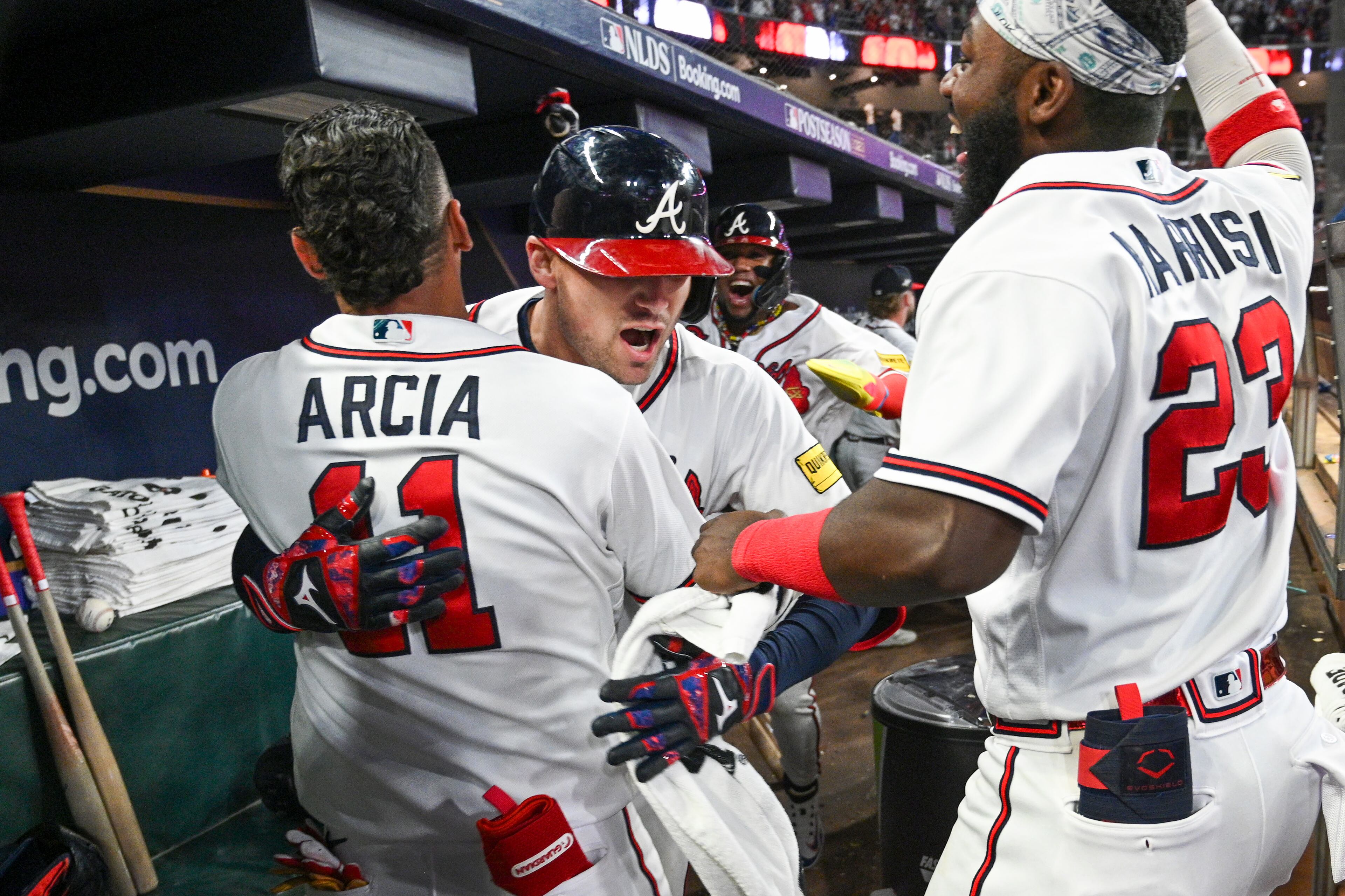Atlanta Braves’ Orlando Arcia (11) and Michael Harris II (23) celebrate with Austin Riley after his two-run home run against the Philadelphia Phillies during the eighth inning of NLDS Game 2 in Atlanta on Monday, Oct. 9, 2023. (Hyosub Shin / Hyosub.Shin@ajc.com)