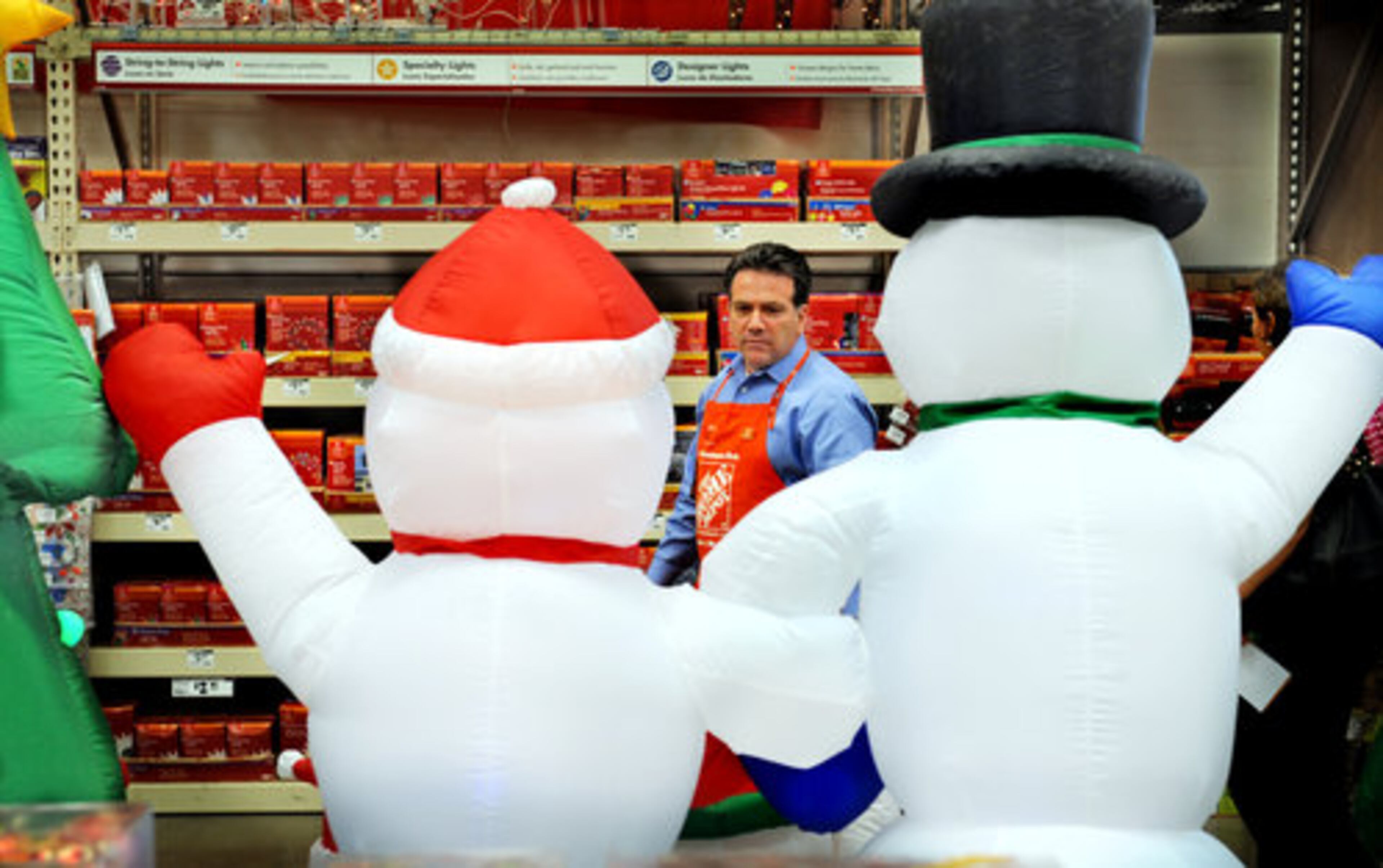 At Home Depot, outdoor, inflatable Santa Clauses, solar-powered LED lights and Hanukkah decorations are featured prominently at the front of the big-box store.