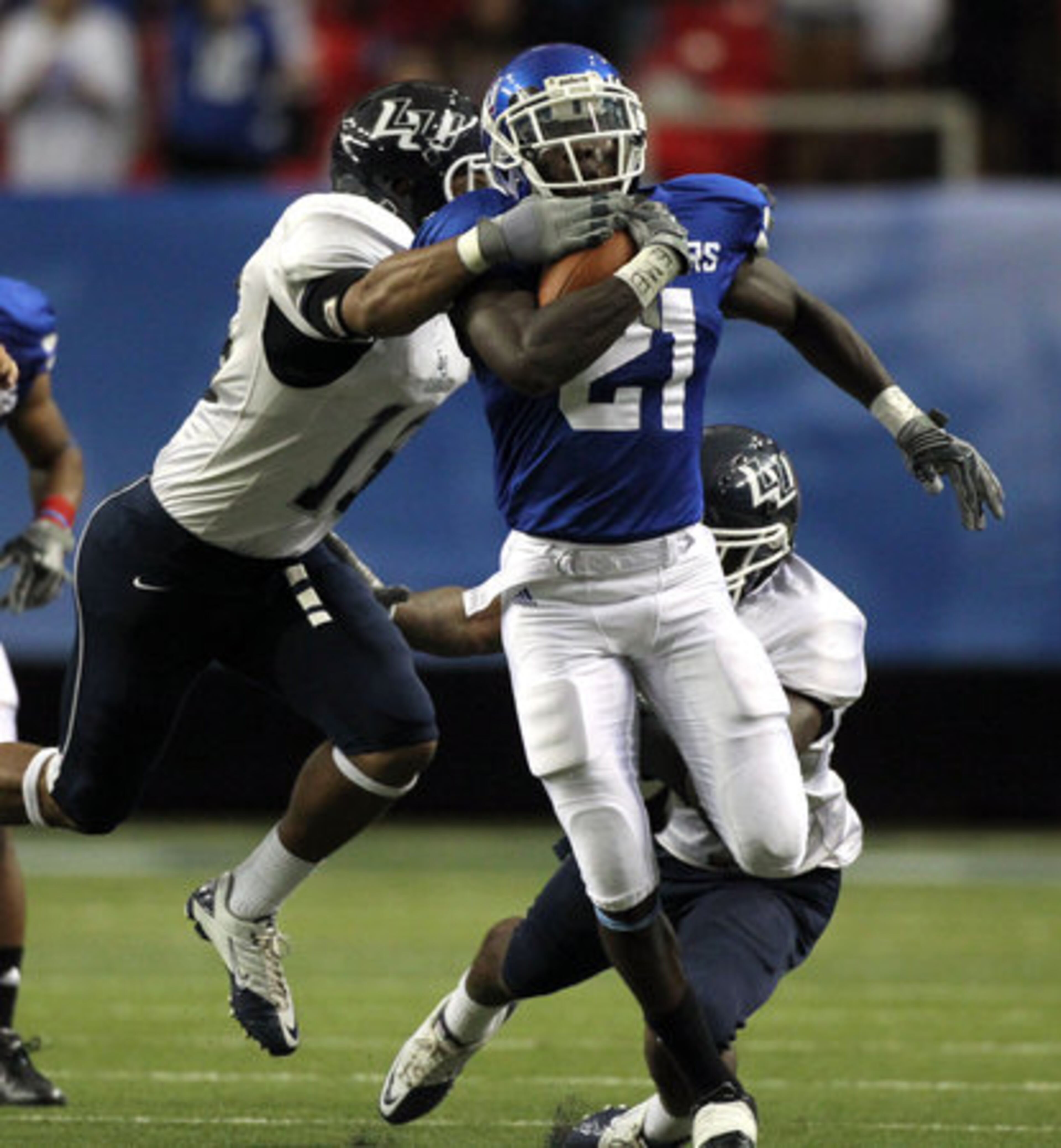 Georgia State University running back Travis Evans (21) runs for a large gain as he is tackled by Lambuth defenders in the second half of their game against Lambuth Saturday afternoon at the Georgia Dome in Atlanta, Ga., Sept. 11, 2010. Evans had a touchdown in the third quarter for GSU.
