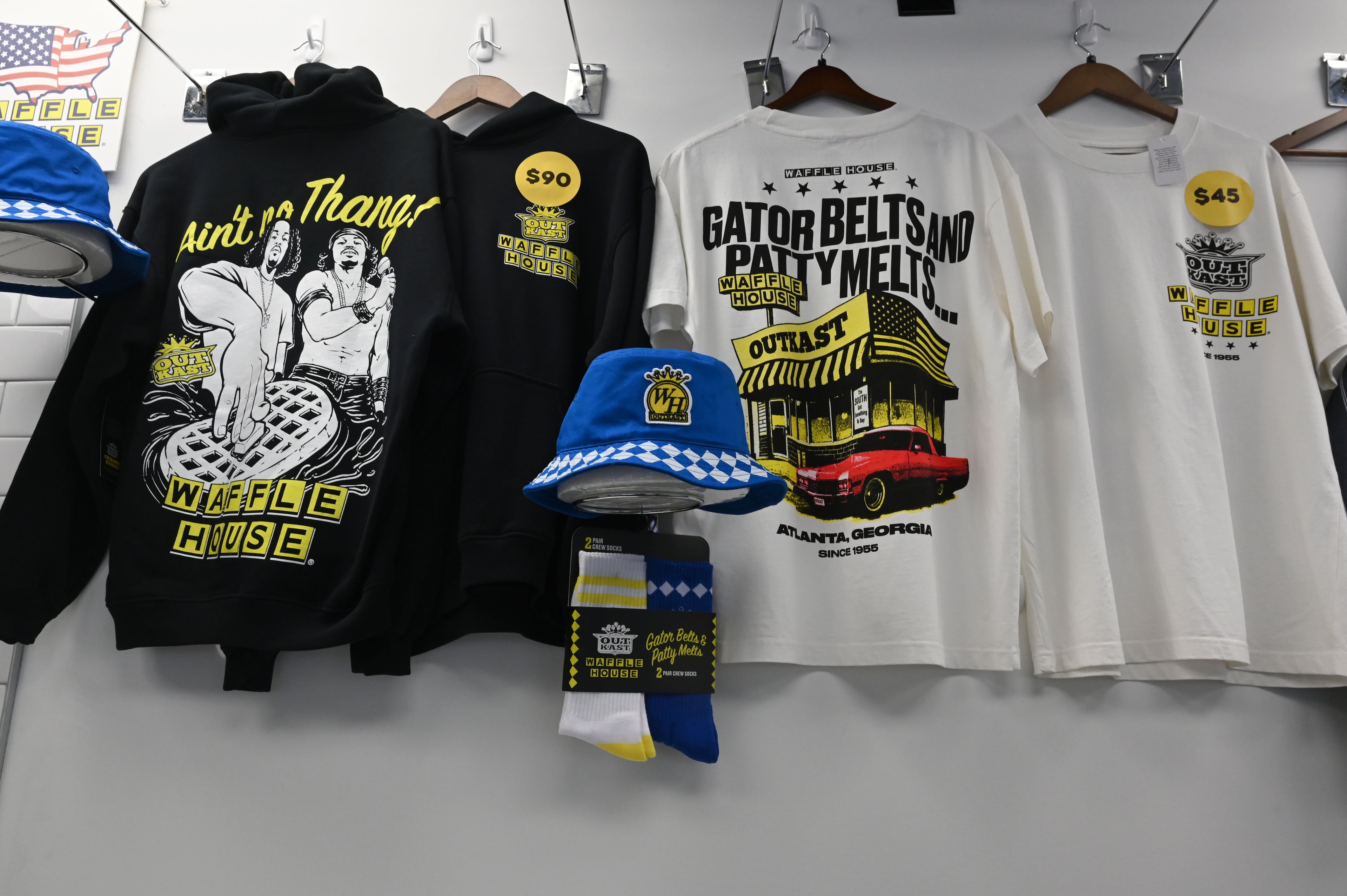 Some of the limited-edition apparel and accessories from the Outkast and Waffle House collaboration is displayed at the pop-up store. (Hyosub Shin/AJC)